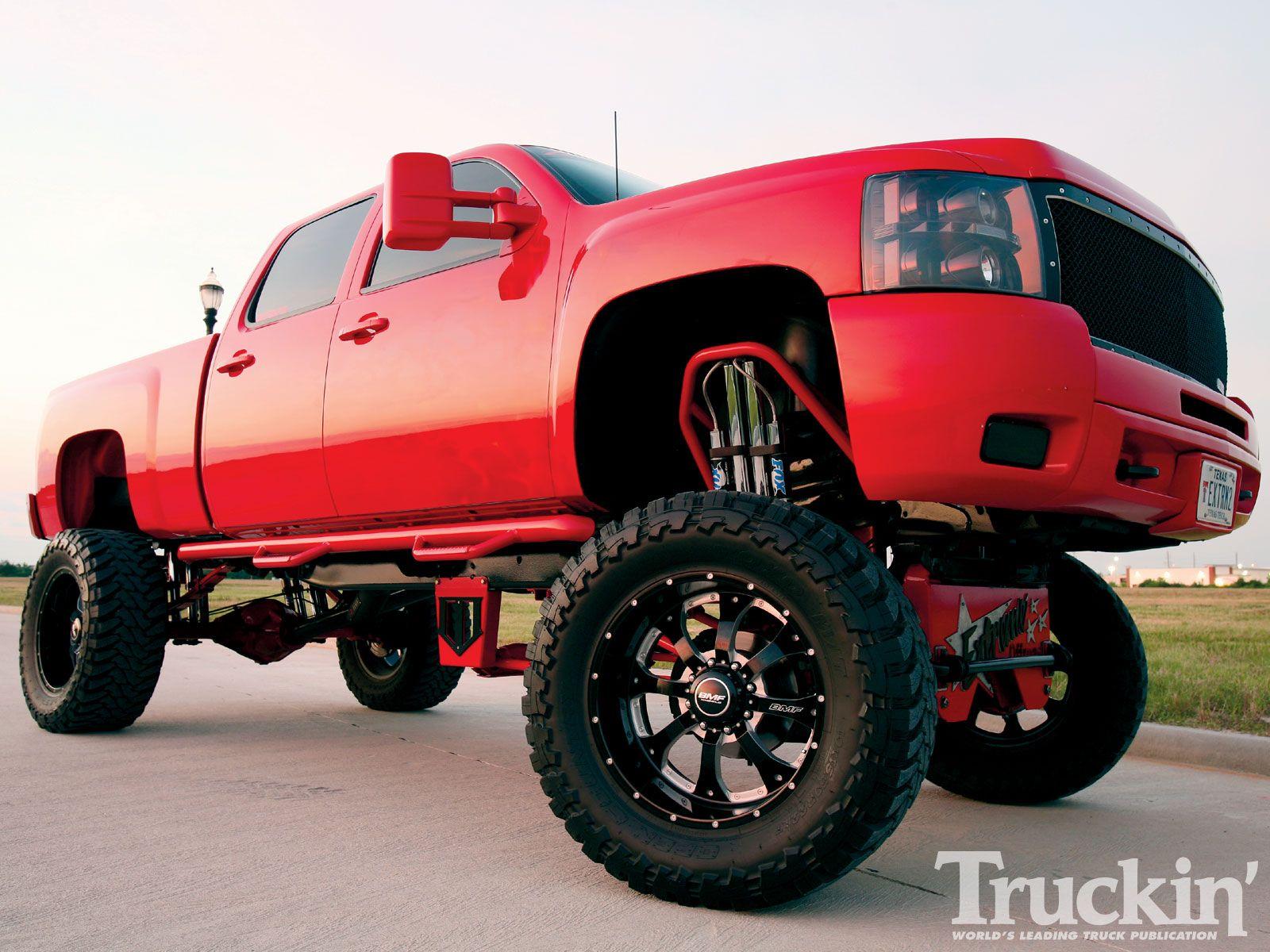 jacked up trucks red