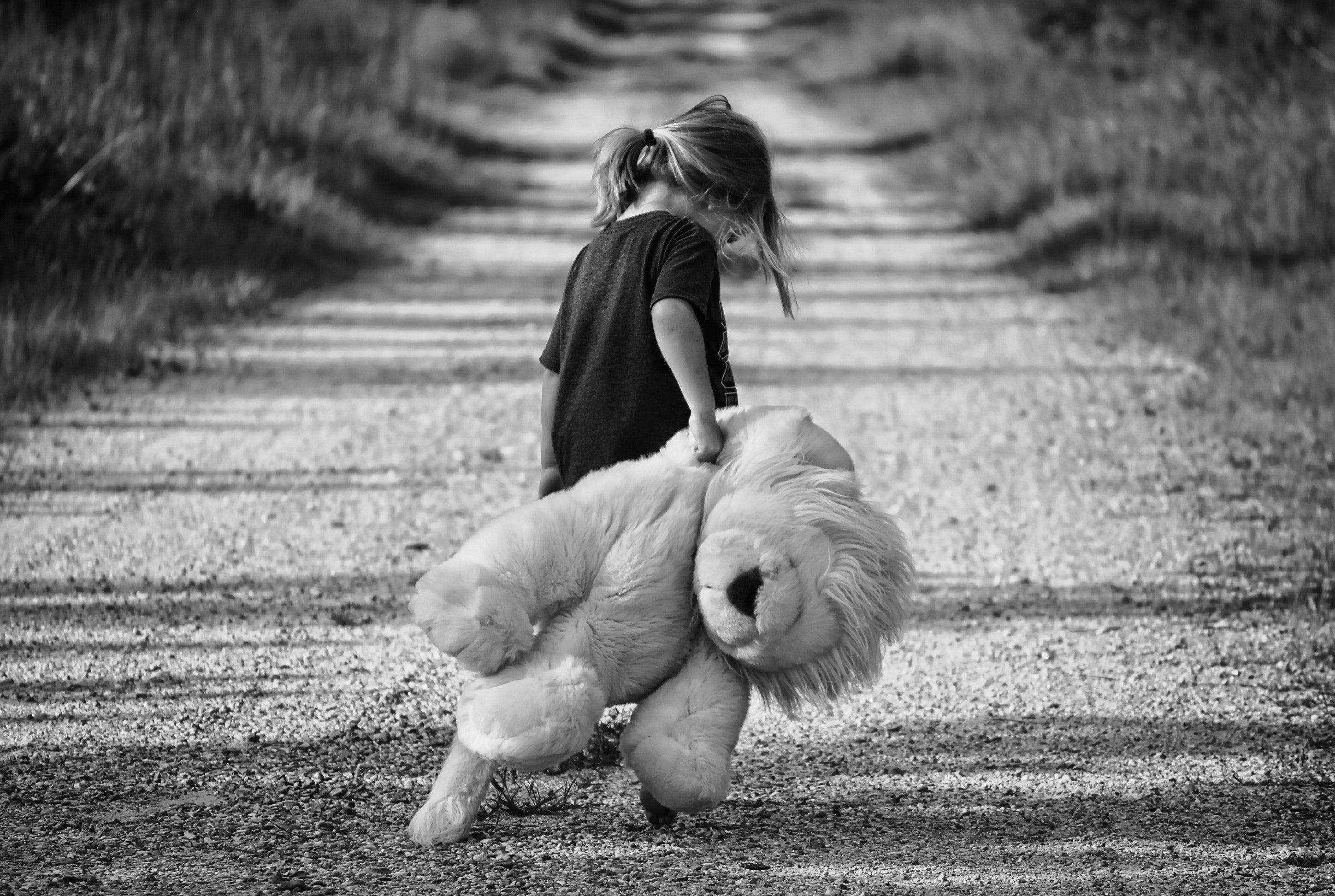 Grayscale Photography of Girl Holding Plush Toy · Free