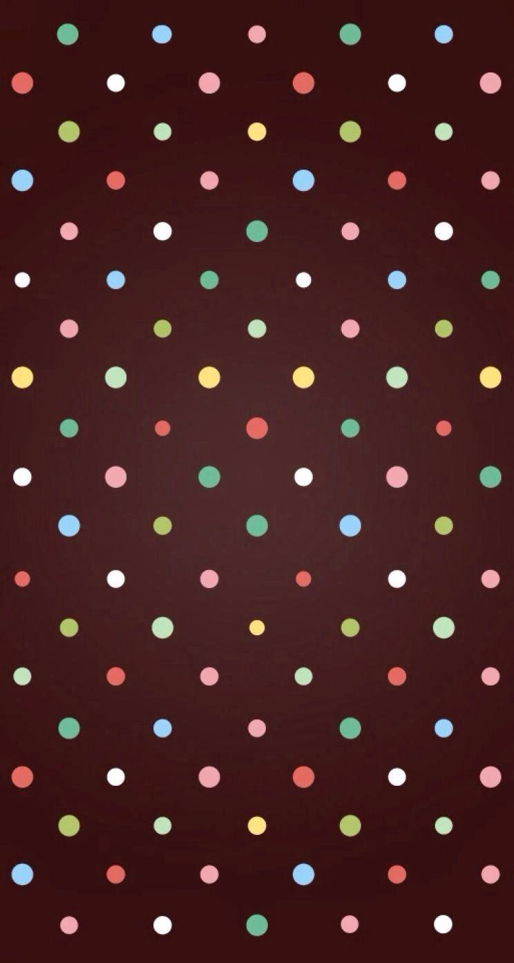 Brown background with multi color dots. Wallpaper. Wallpaper