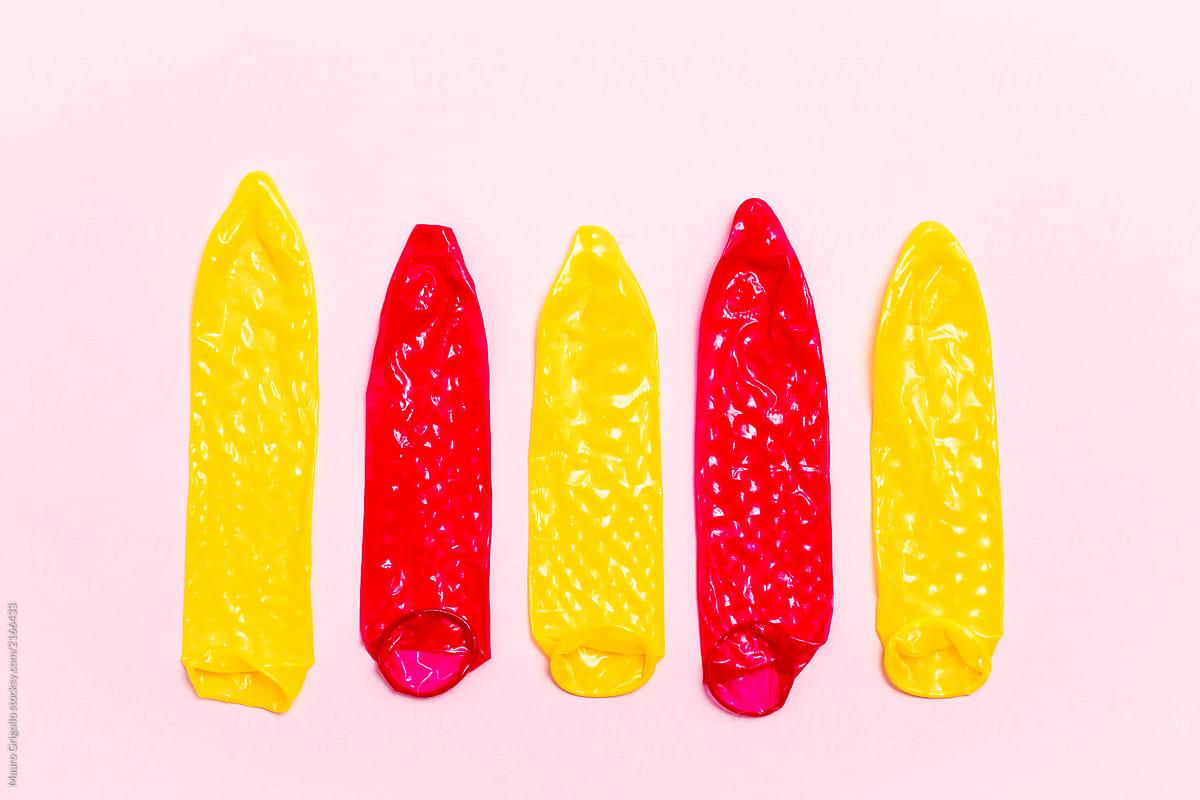 Colorful Condoms On Pink Background