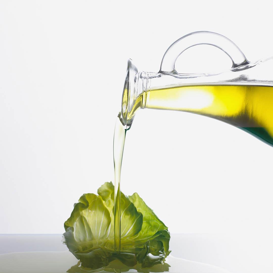 Olive Oil Pouring On Lettuce Leaf