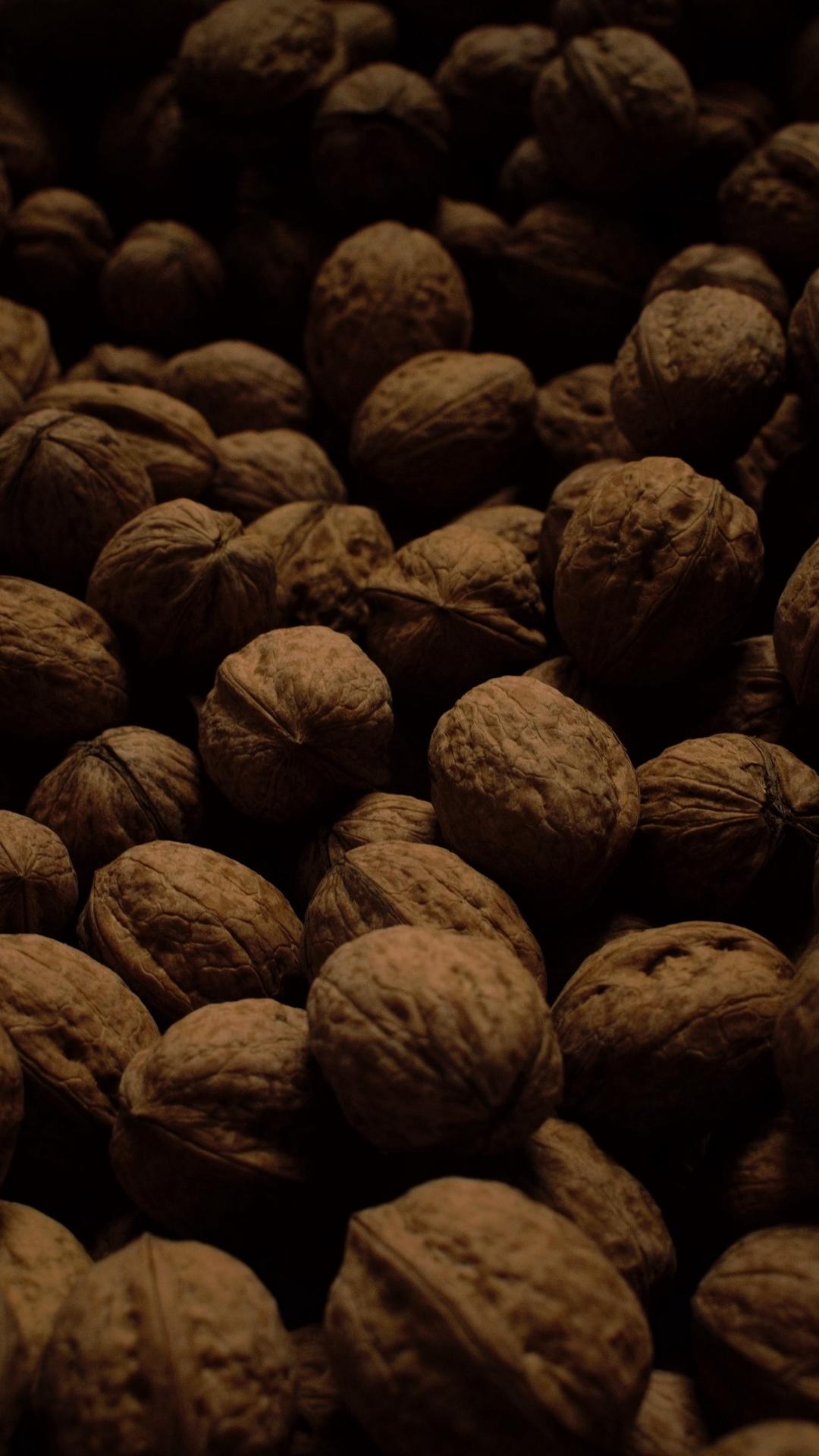 Download wallpaper 1080x1920 walnuts, dark, many, nuts, harvest