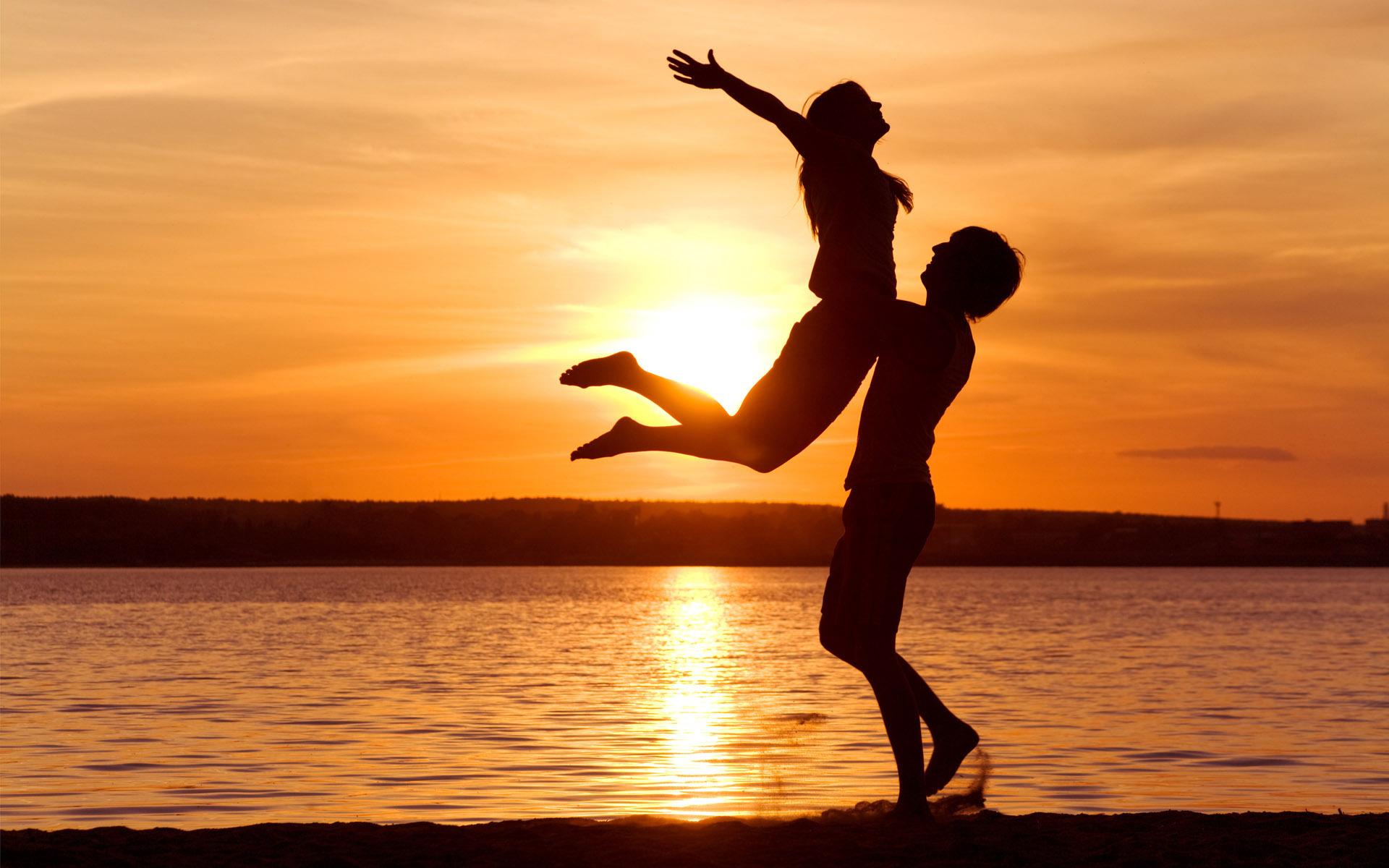 Happy Couple on the Beach at Sunset widescreen wallpaper. Wide