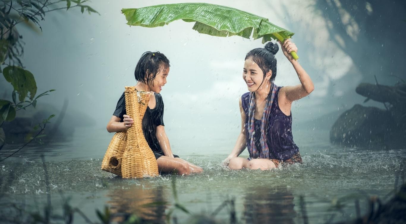 Happy Mom And Son Standing In The Rain Wallpaper