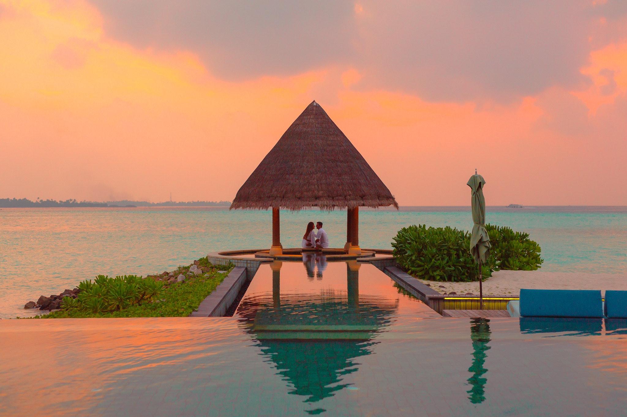 Couple Under Hut Beside Sea and Infinity Pool · Free