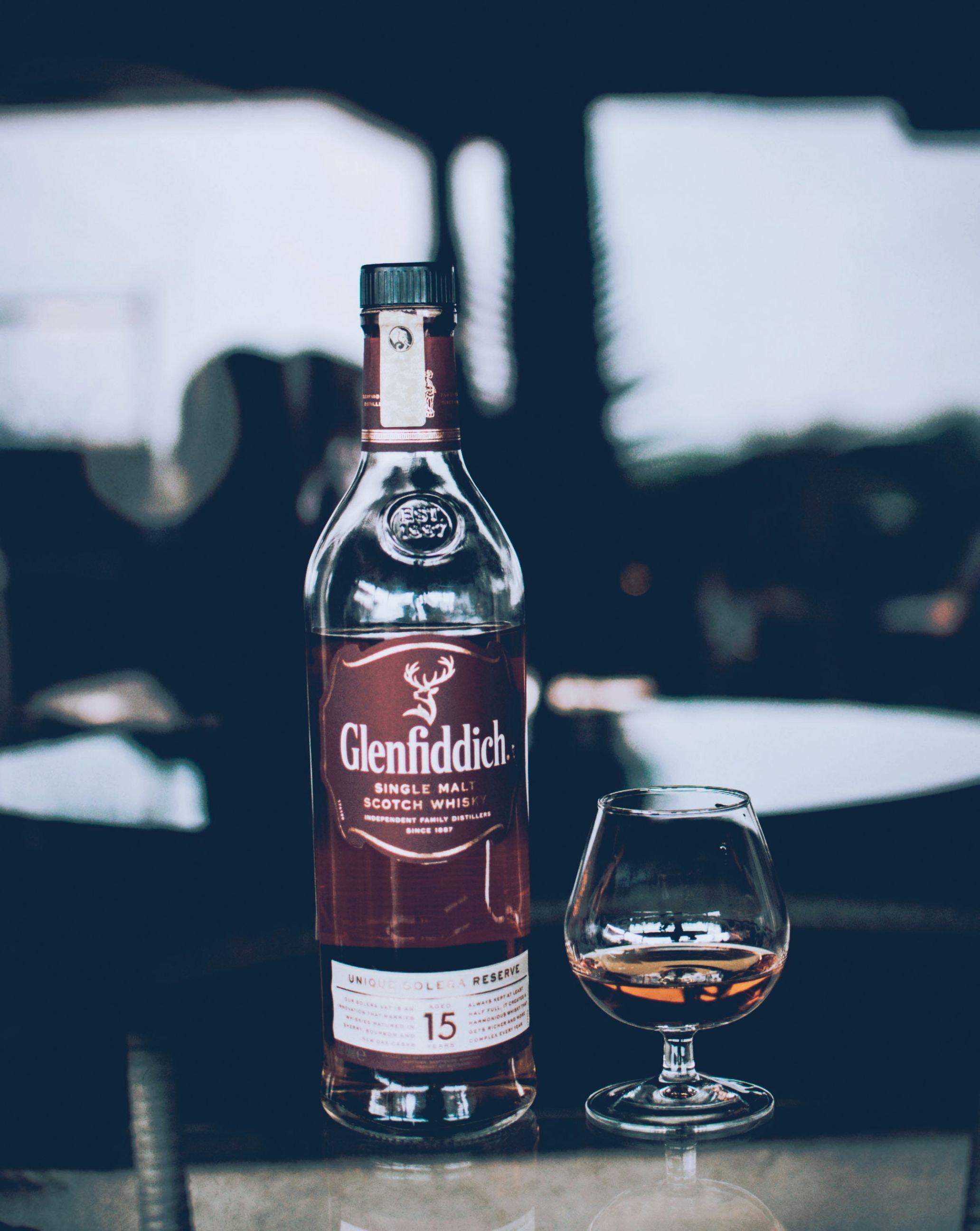 Glenfiddich Bottle Beside Wine Glass · Free