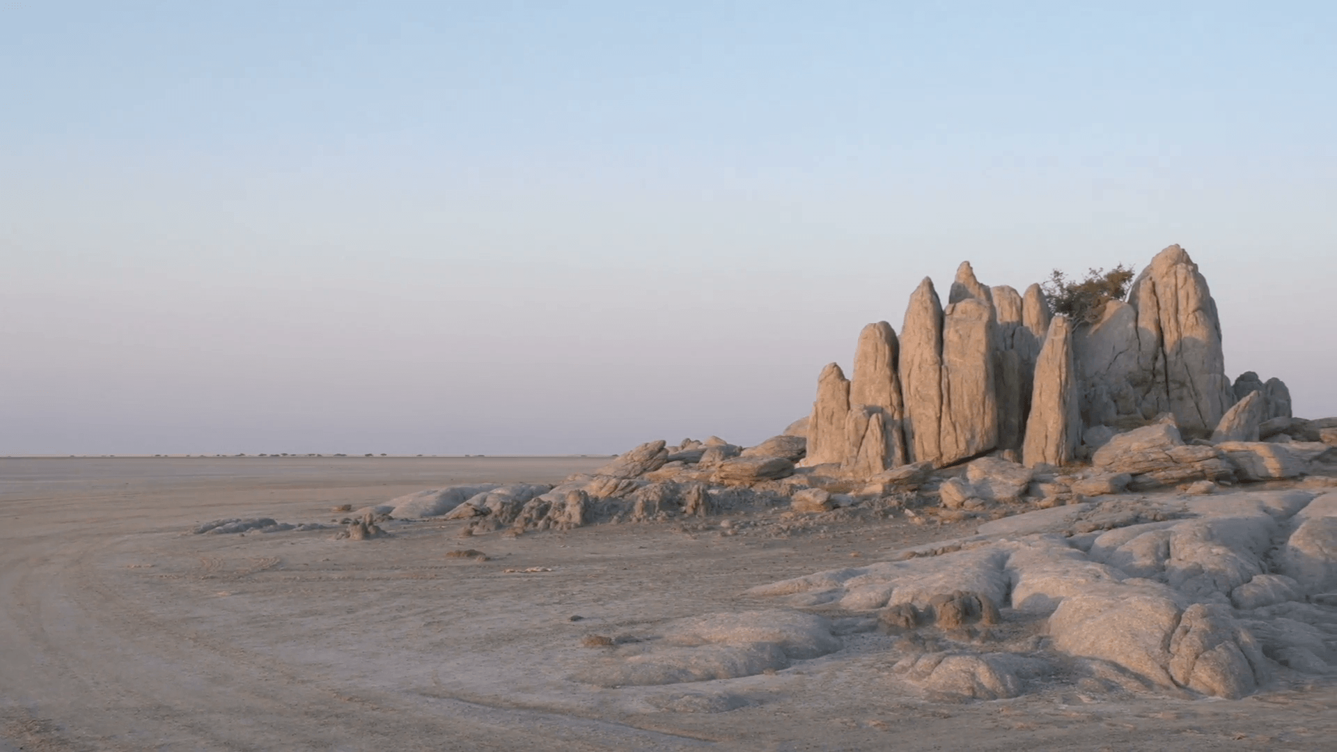 Panning shot of Makgadikgadi Pans and rock formations at Kubu Island