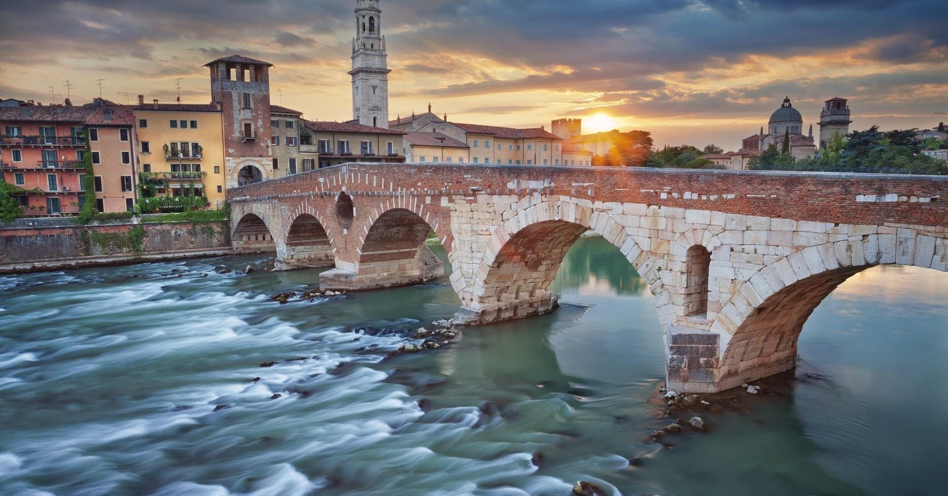 Download 1920x1005 Italy, Verona, River, Bridge, Sunset, Buildings