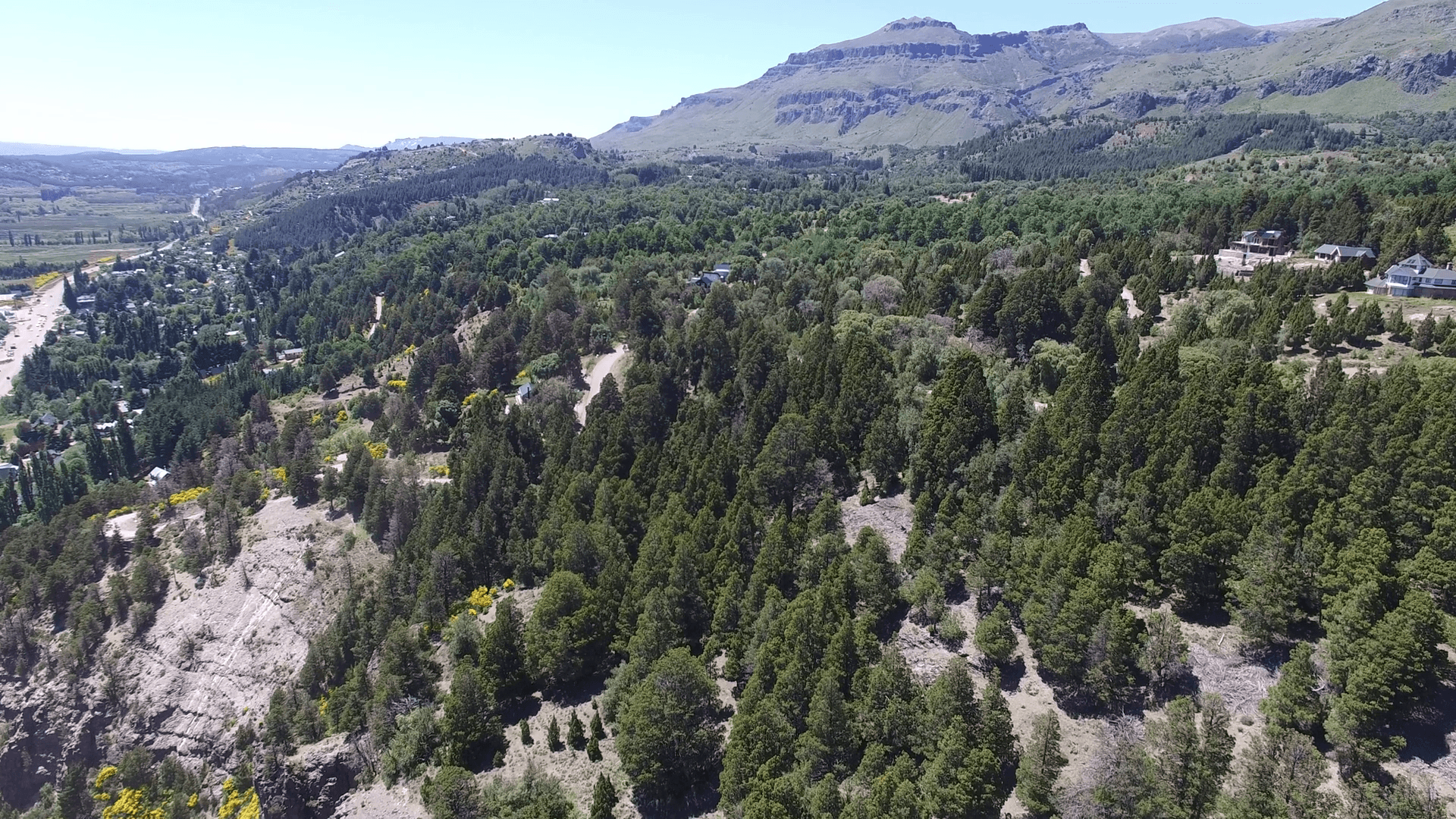 Aerial drone scene of houses in the woods in mountain in south