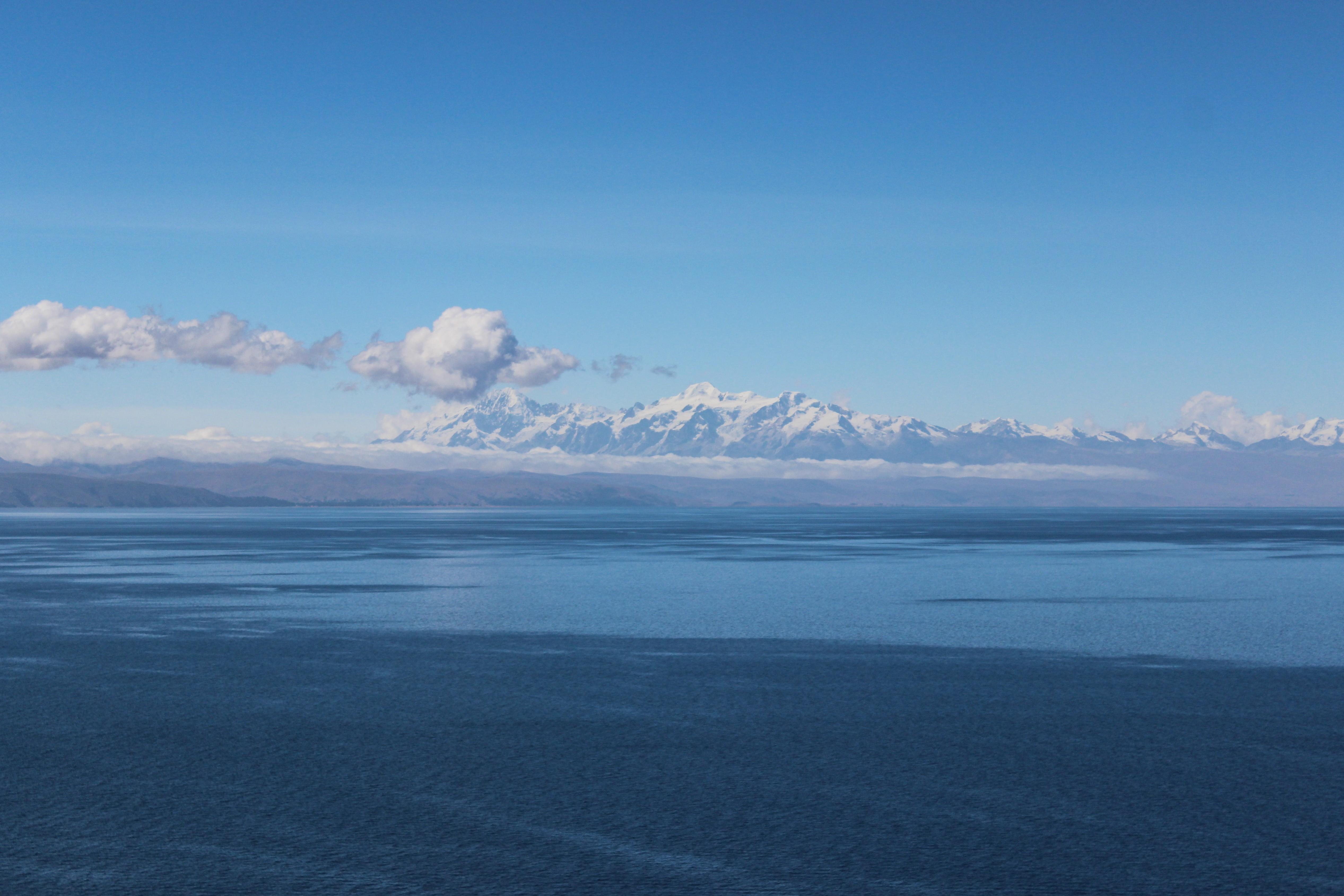 sea mountains blue lake lake titicaca titicaca clouds clear sky