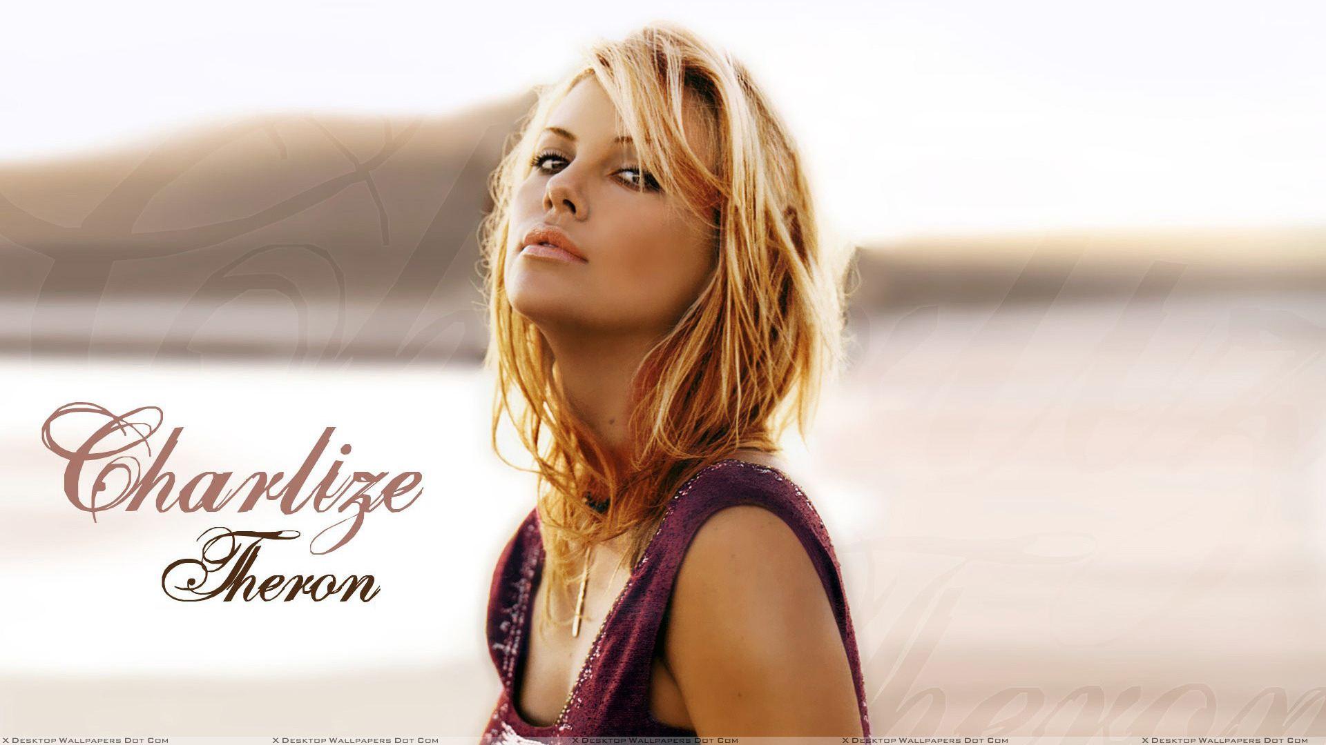 Charlize Theron In Golden Hairs N Looking At Camera Wallpaper