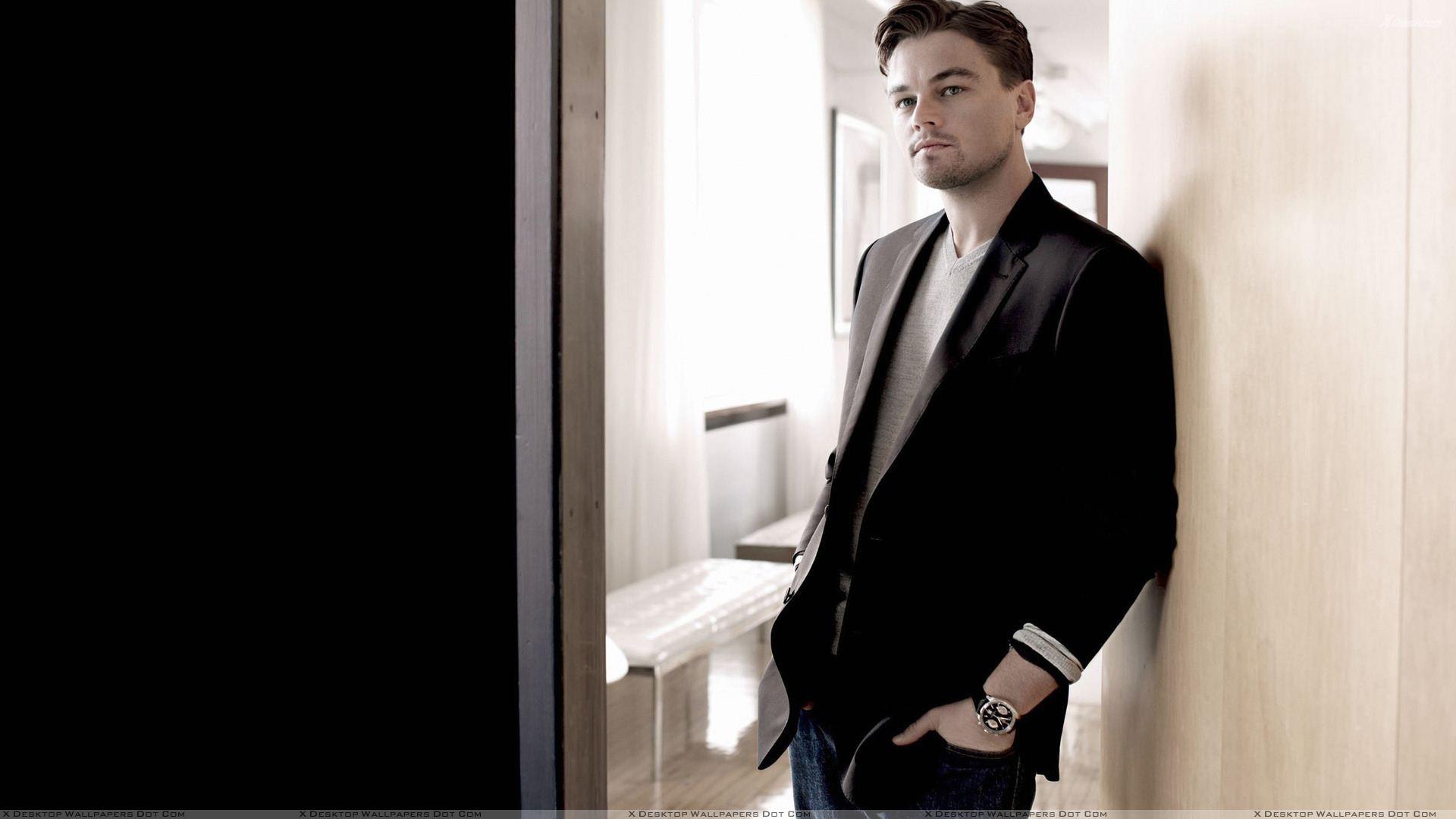 Leonardo DiCaprio Looking Smart In Black Coat N Blue Jeans Wallpaper