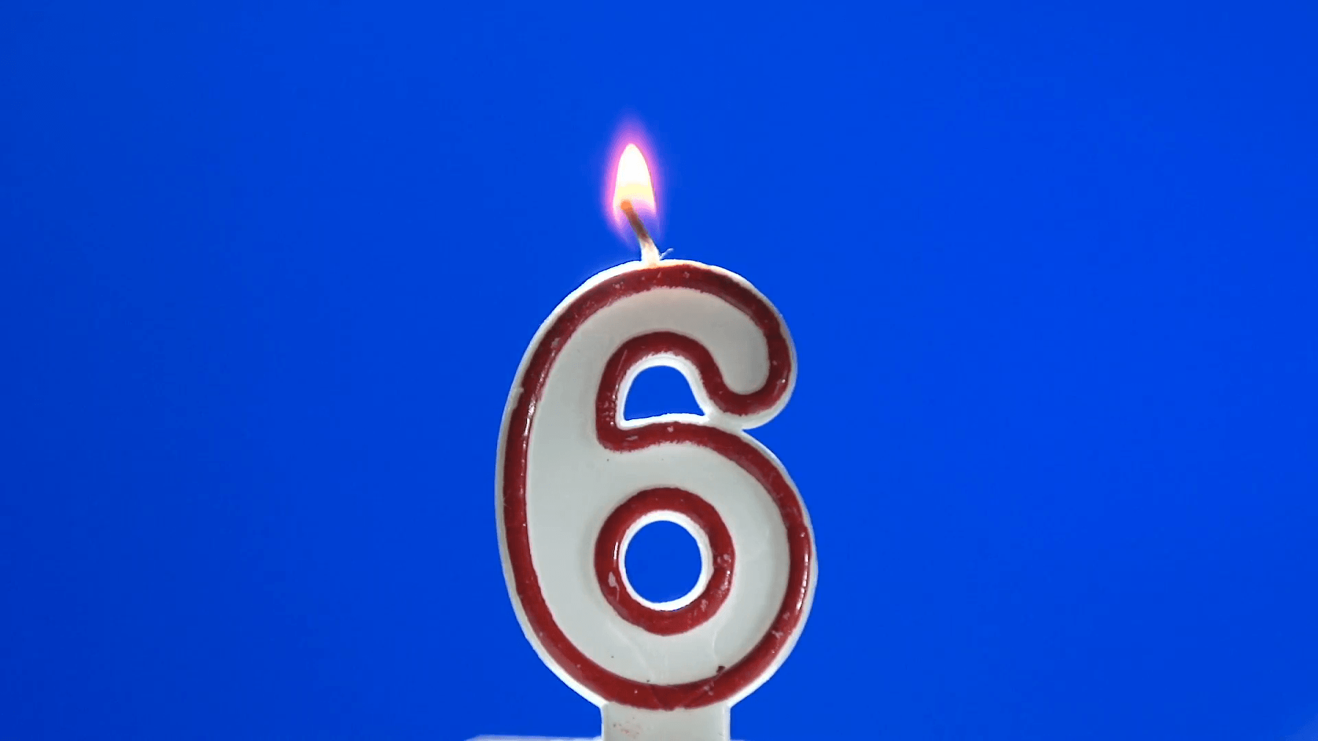 Number 6 birthday candle burning out at the end Stock