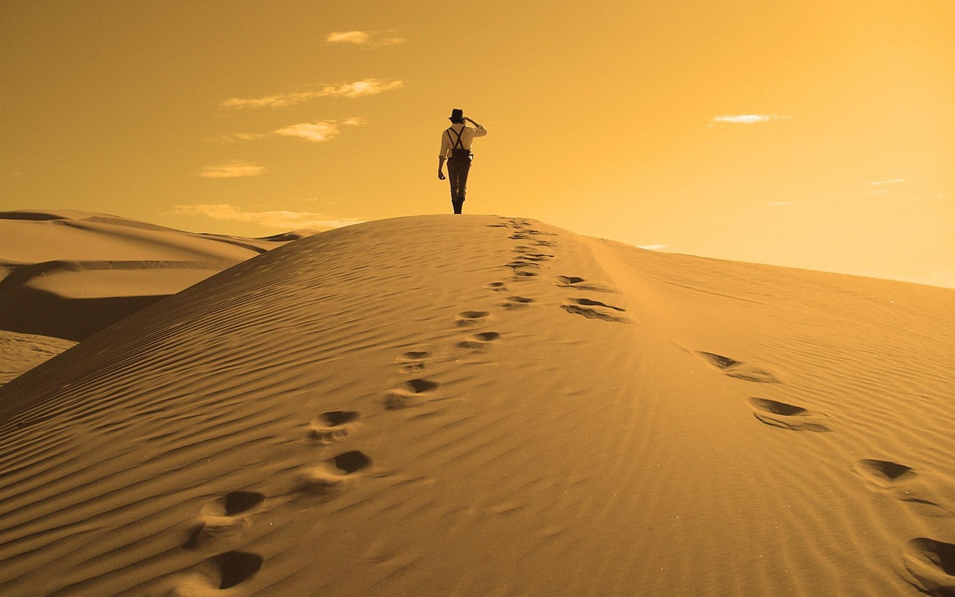 A Man Walking In Desert Wallpaper
