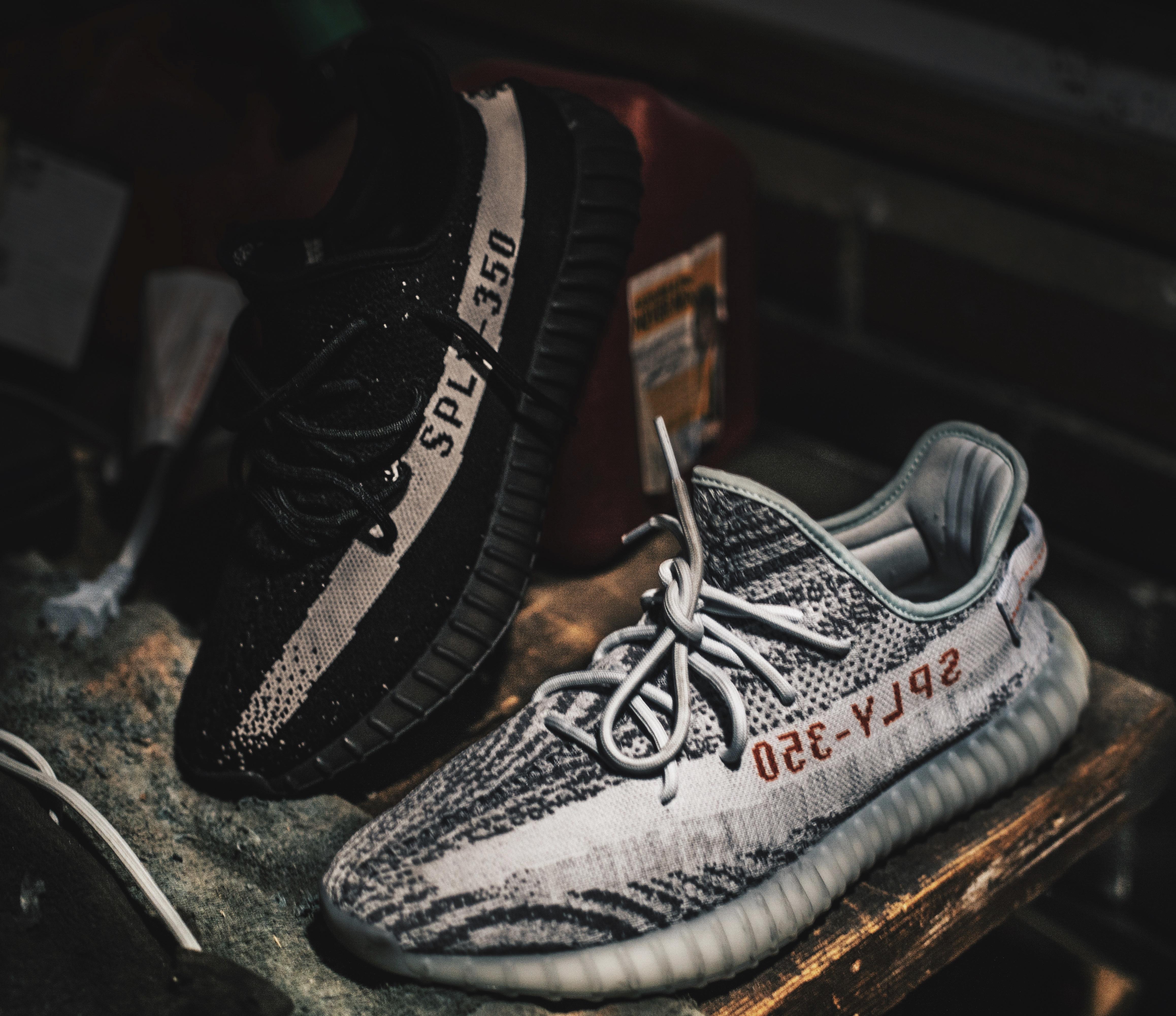 Two Unpaired Black And Gray Adidas Sply 350 V2 Wallpaper
