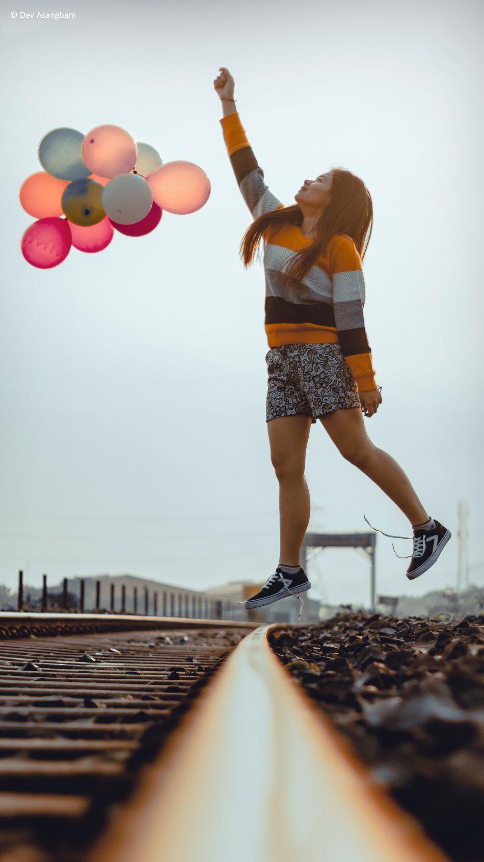 Happy Girl Jumping Balloons Train Track Photography. Short girls