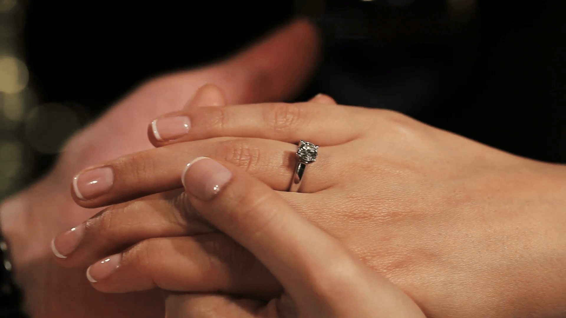 Man holding hands woman with engagement ring with diamond on finger