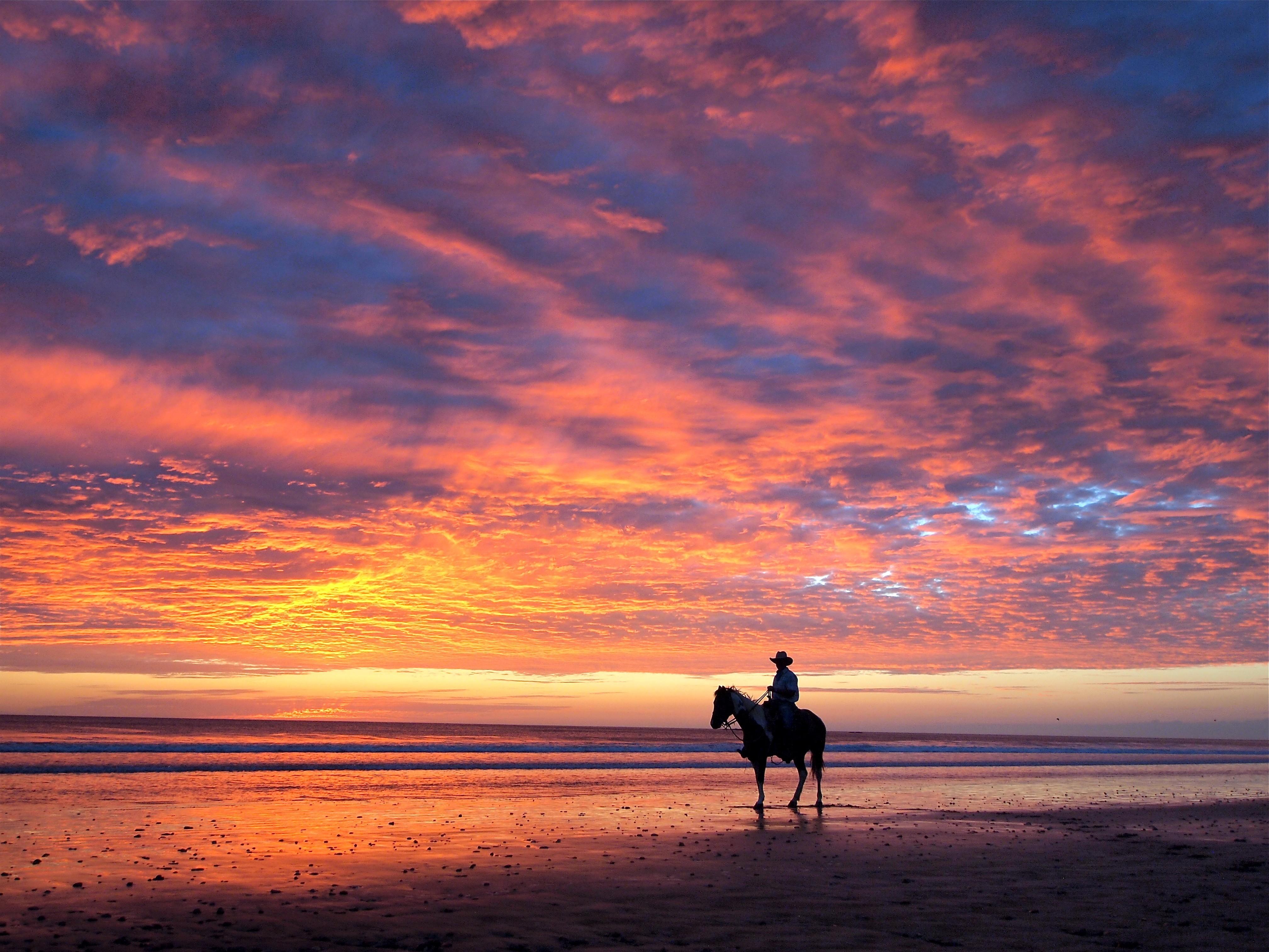 Cowboys horses rider shore sunset wallpaper