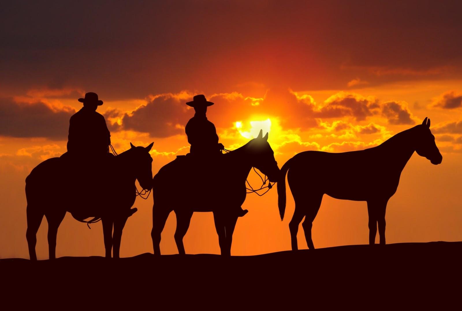 Western Cowboys At Sunset