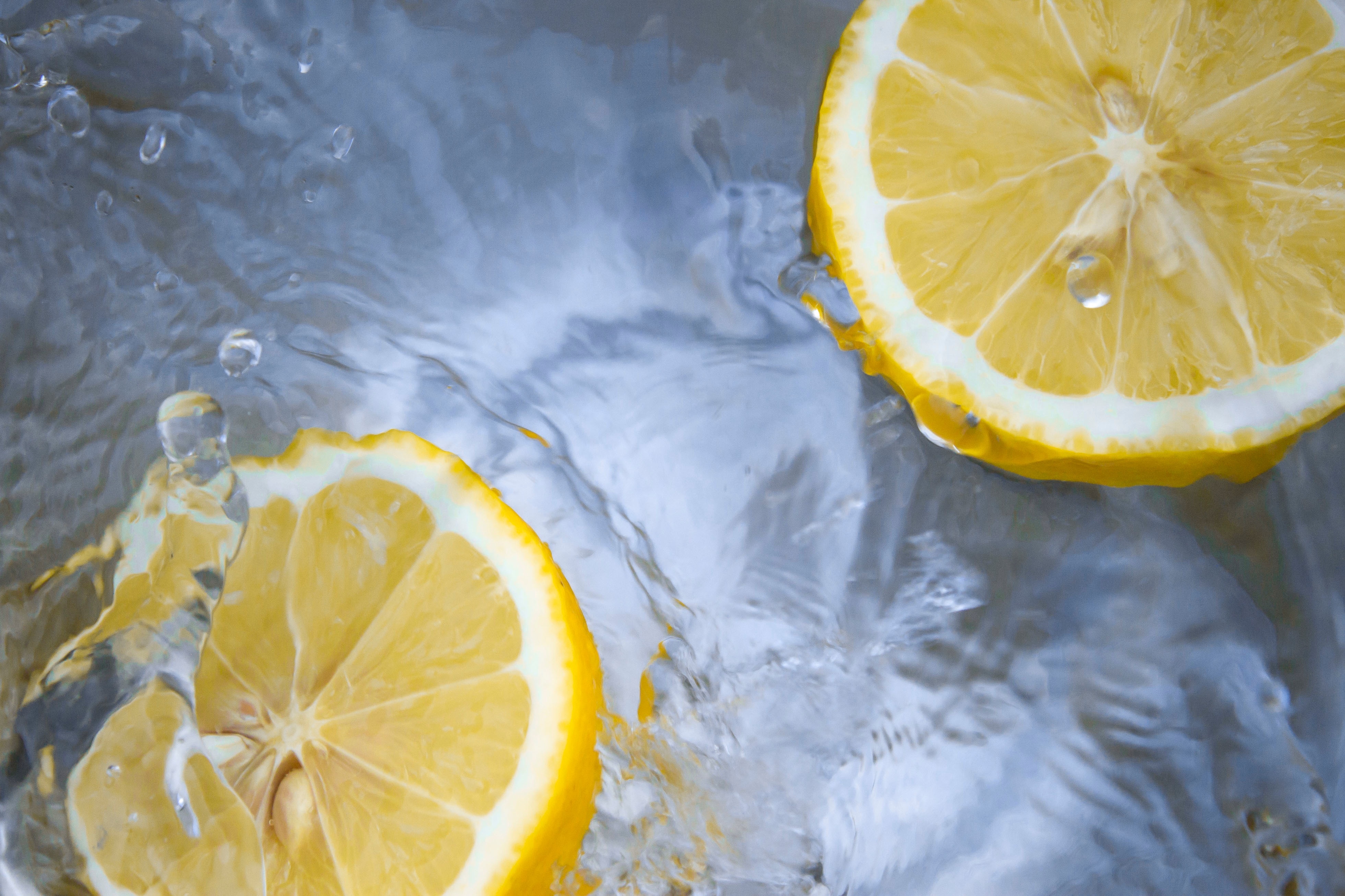 clear water with two lemon garnishes free image