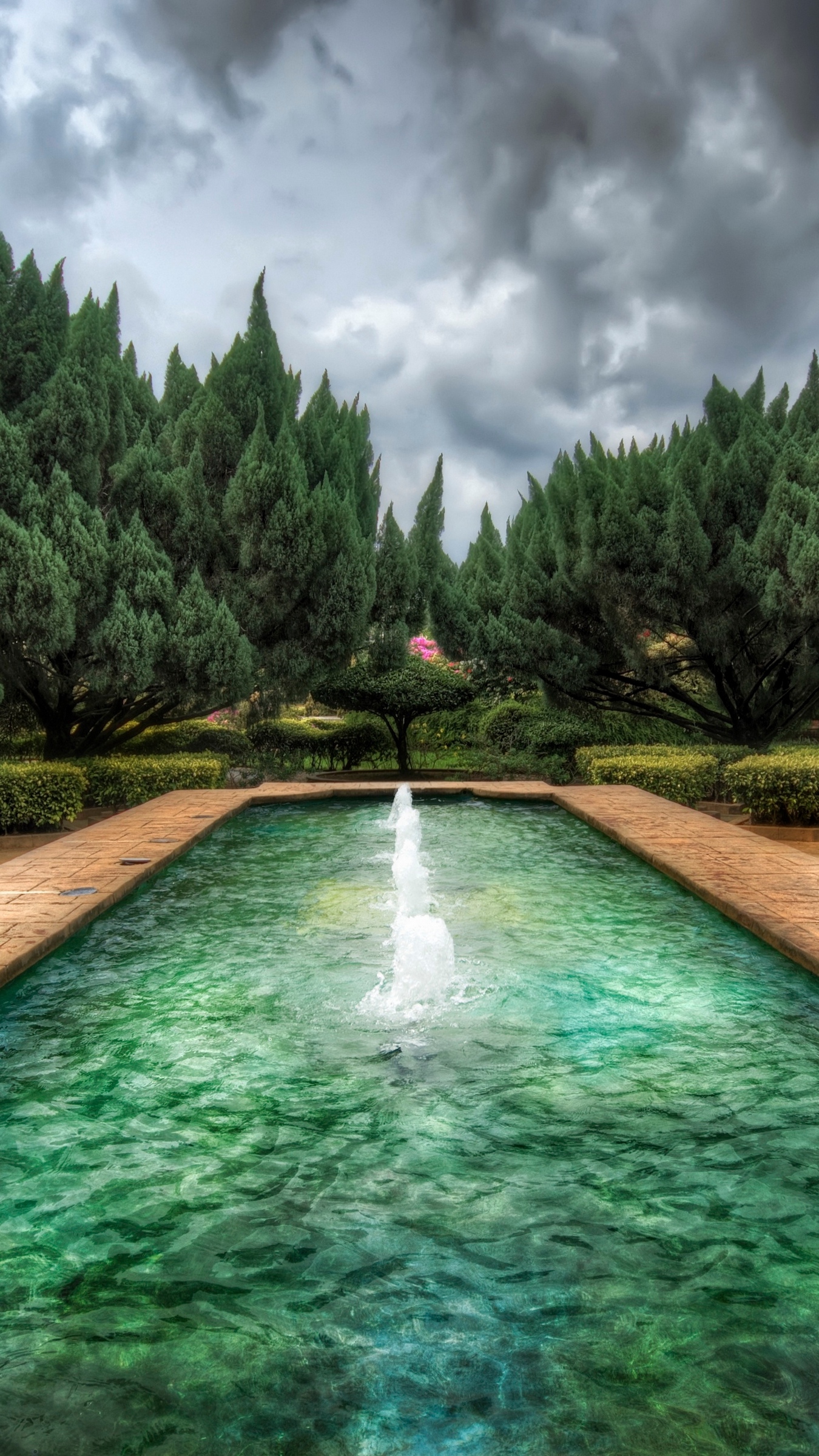 Download wallpaper 1350x2400 pool, fountain, wood, cloudy, colors