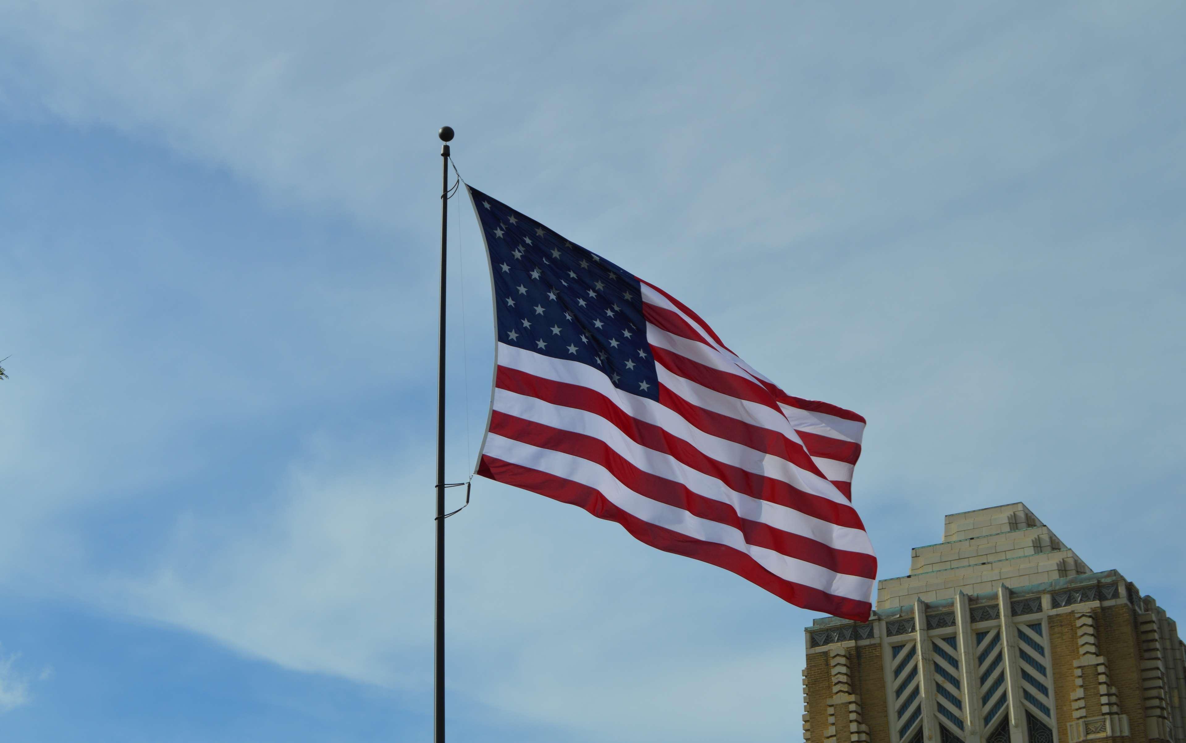 american flag, building, sky 4k wallpaper and background