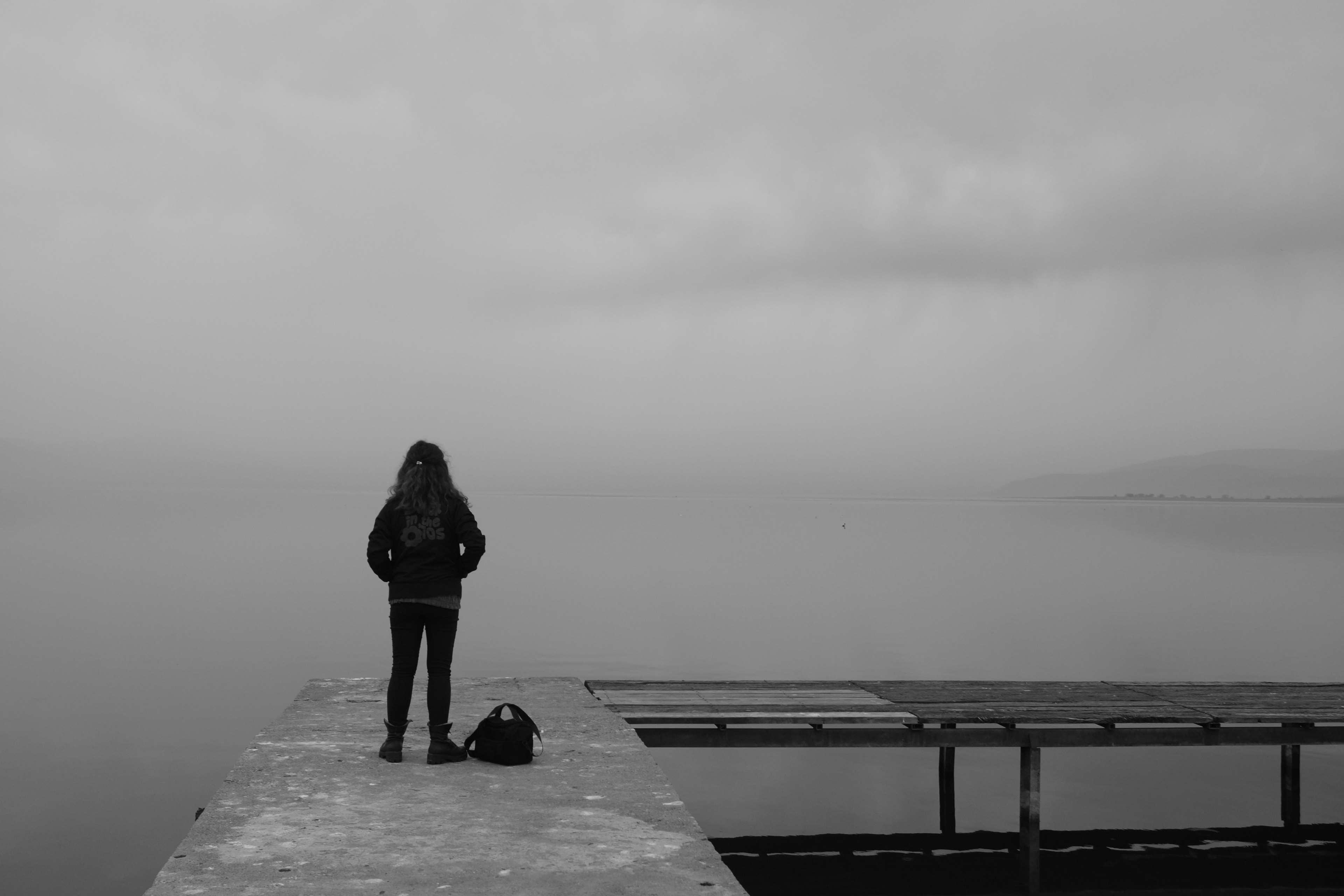 back, backpack, black, black and white, clouds, dock, female