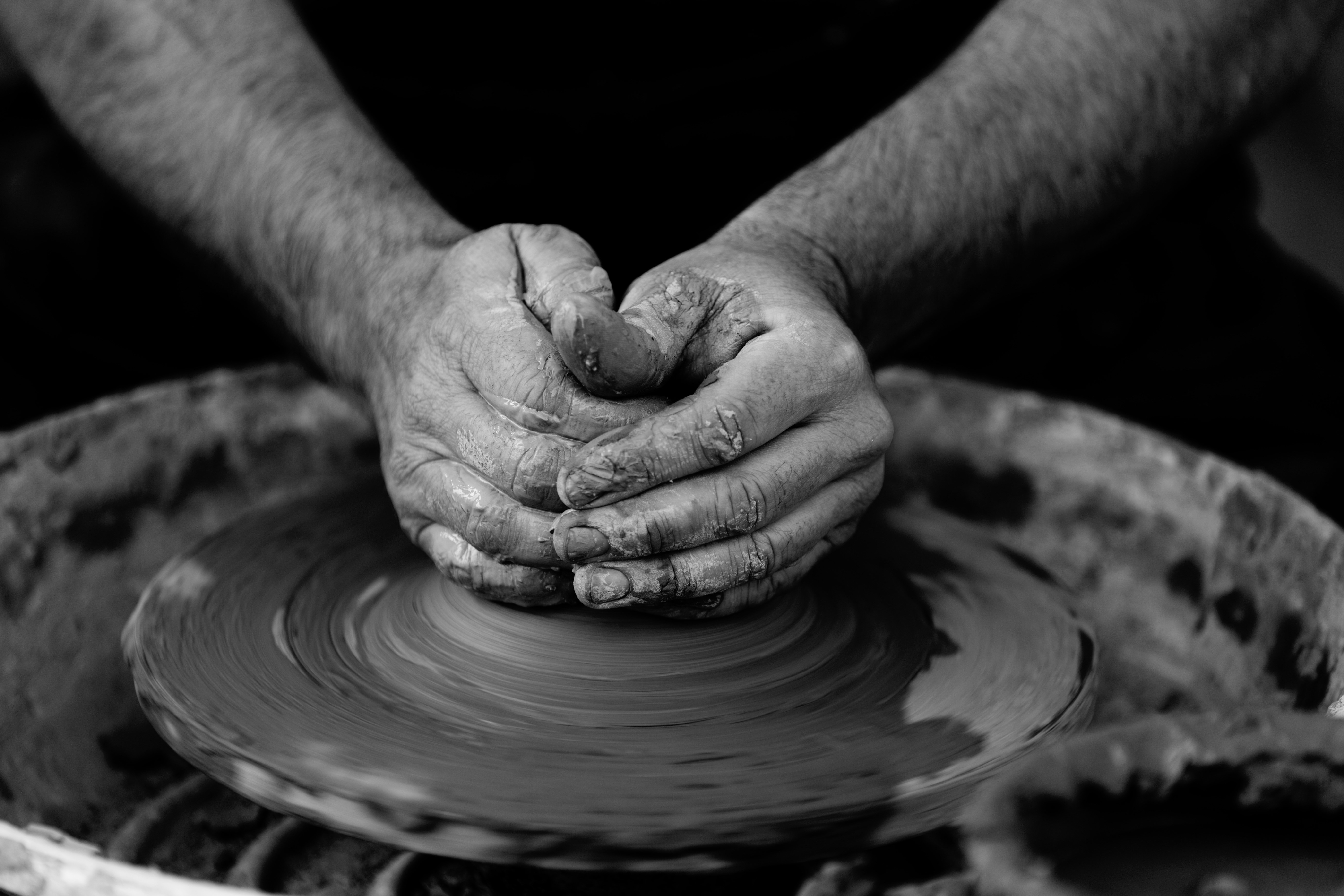 grayscale photo of person make clay pot free image
