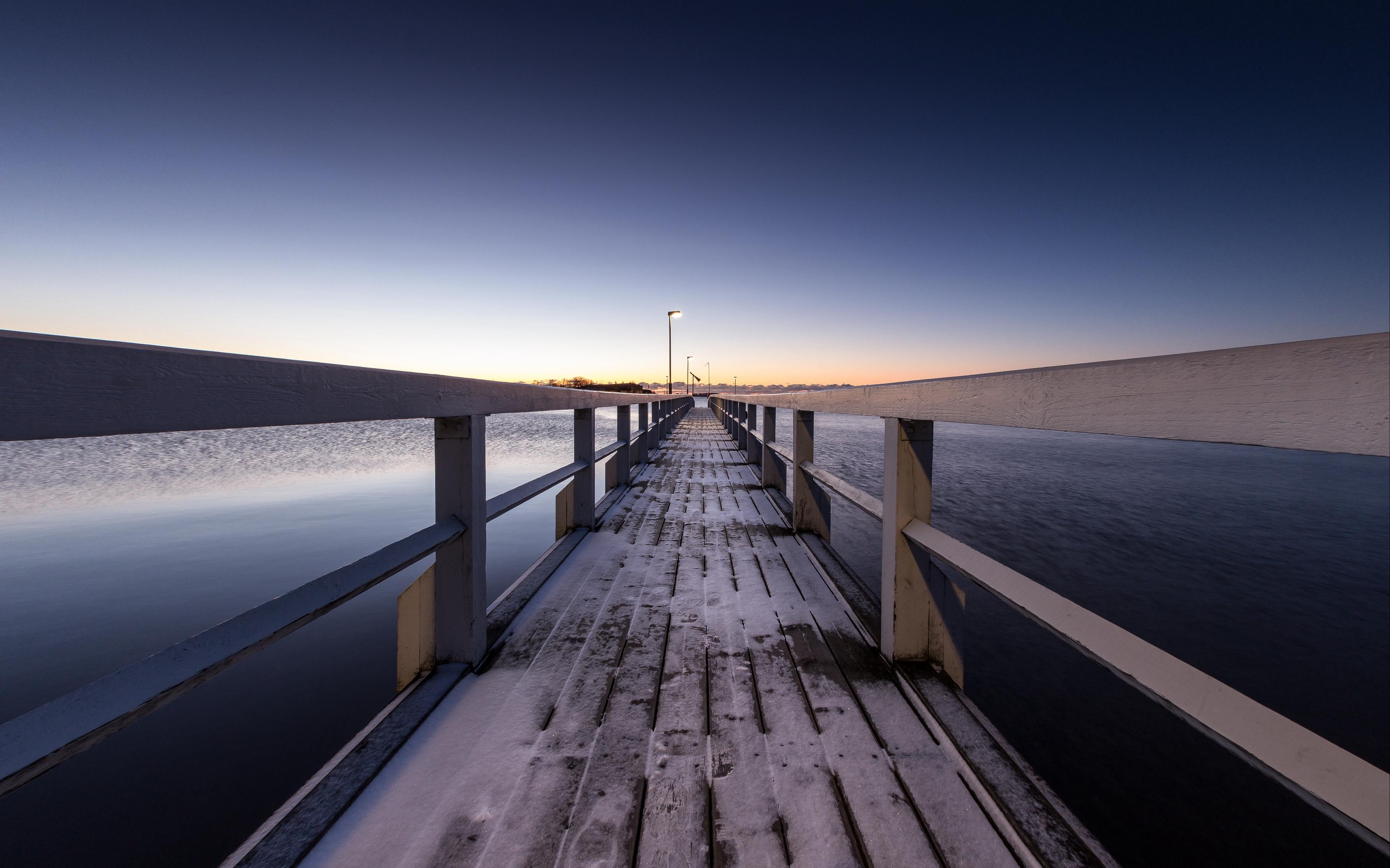 Download wallpaper 3840x2400 pier, snow, bridge, sunset, helsinki