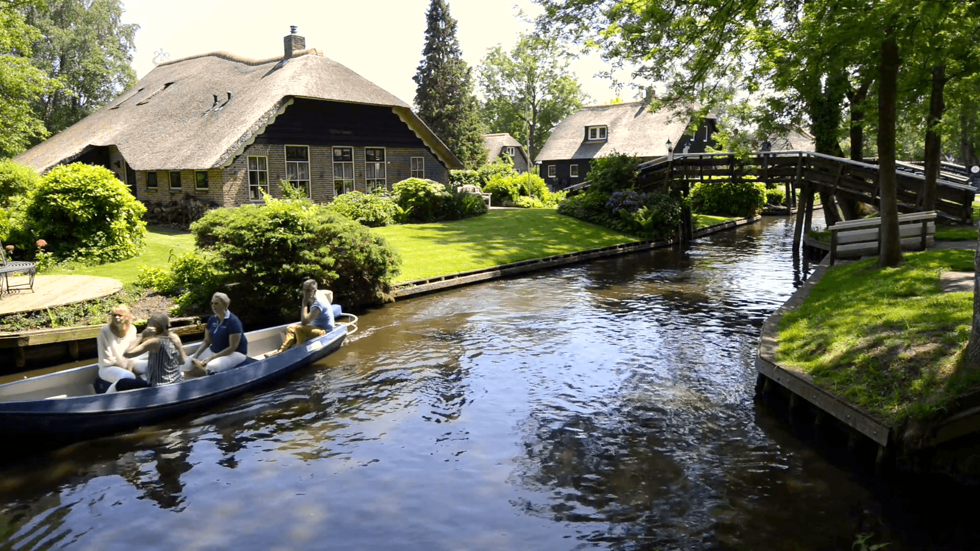 Tourists in a boat on the canal of the village of Giethoorn Stock