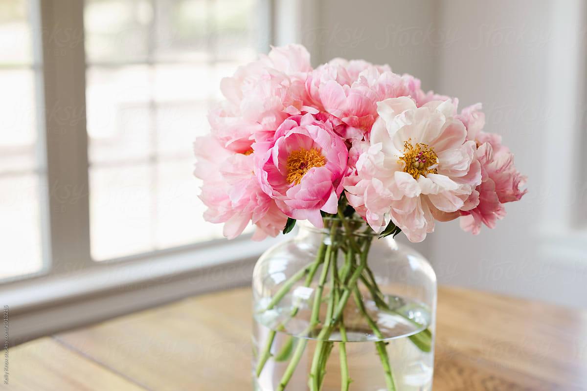 Bouquet Of Pink Peonies In A Glass Vase In A Light Filled Room