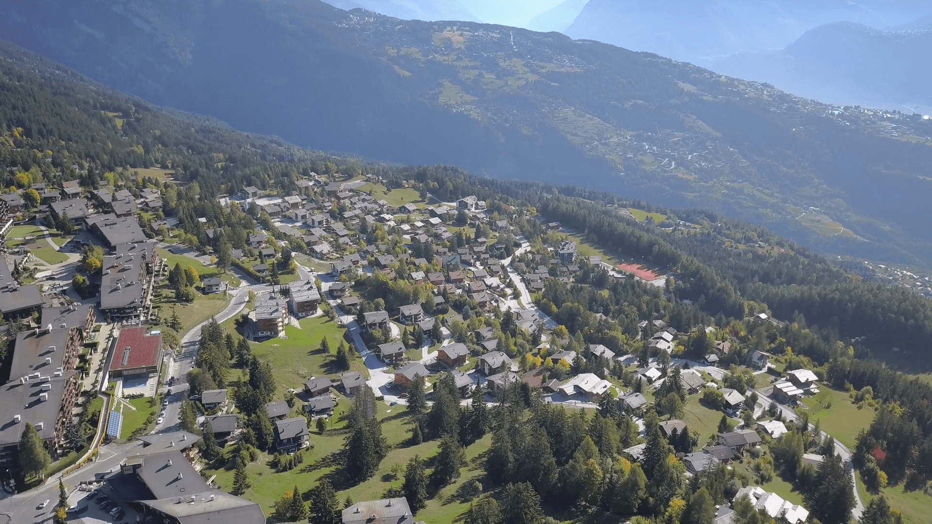 Anzere mountain resort Switzerland. Cinematic aerial shot, little