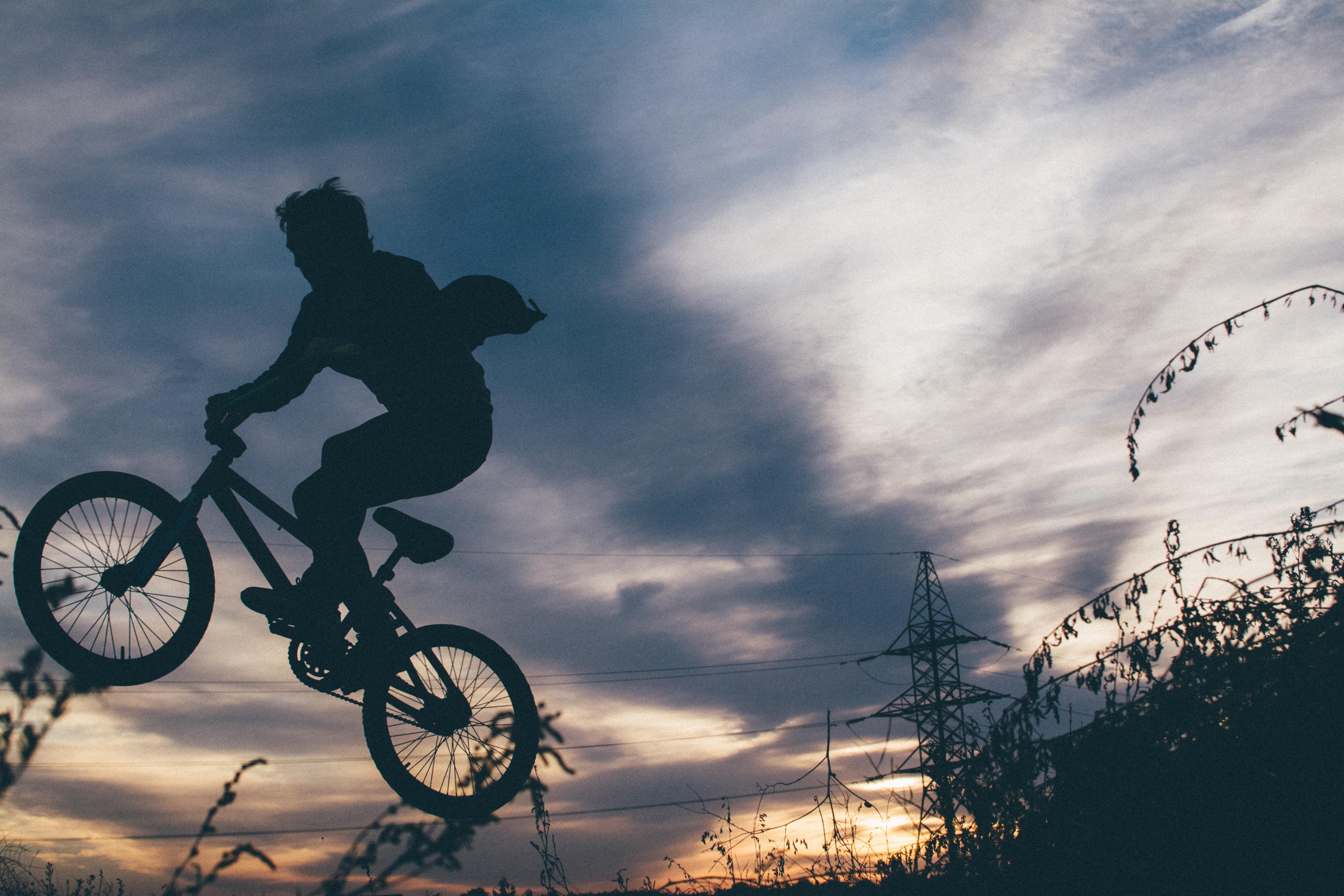 silhoutte of man riding in bmx bicycle free image