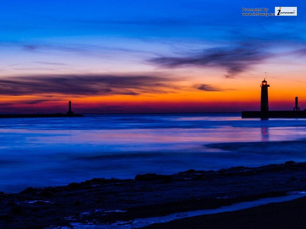 sea beach lighthouse night blue and orange sky. sea beach l