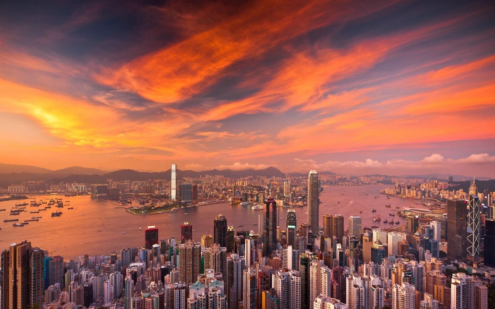 Download 1680x1050 Hong Kong Cityscape, Sunset, Skyscrapers, Clouds