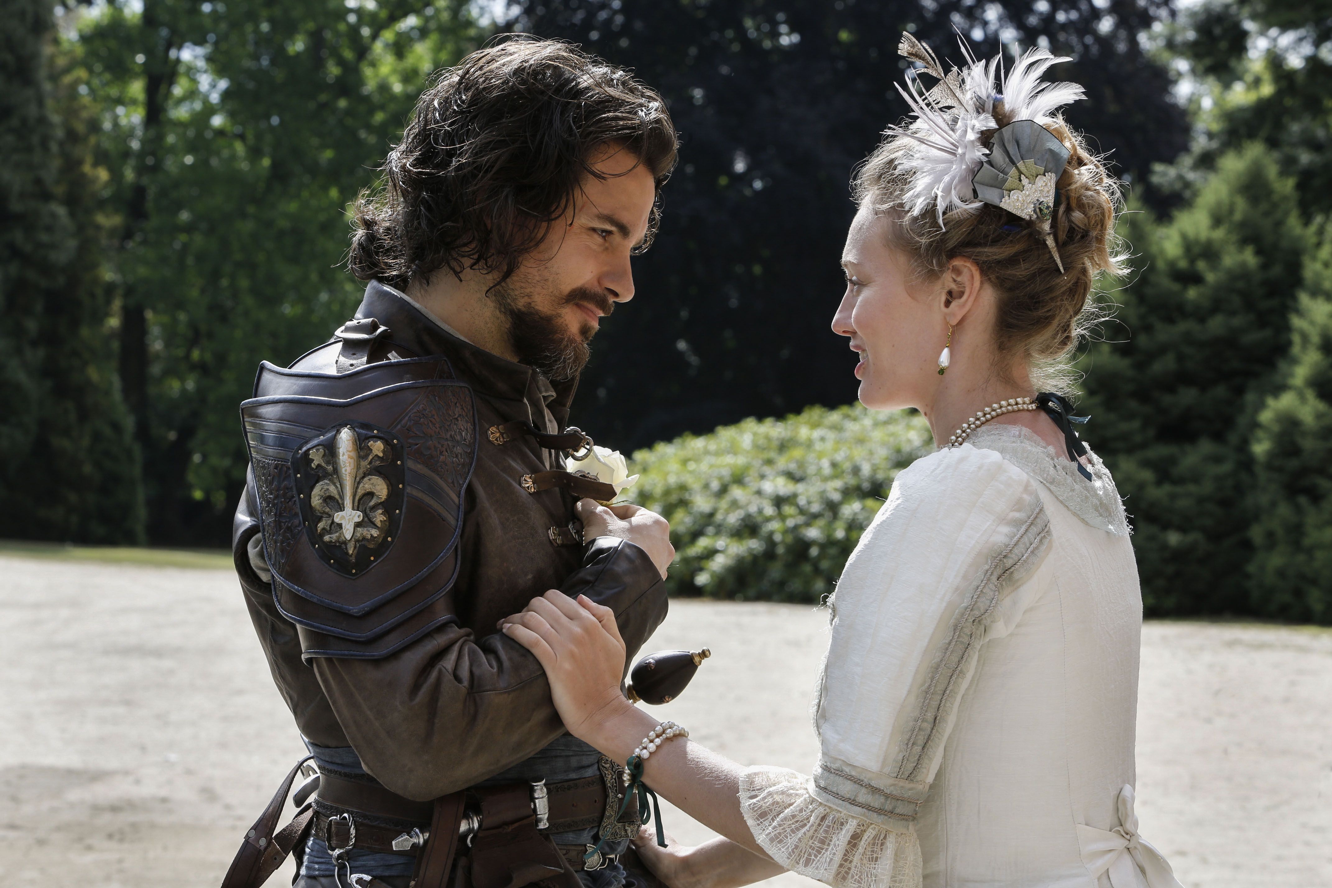 Santiago Cabrera as Aramis and Alexandra Dowling as Queen Anne