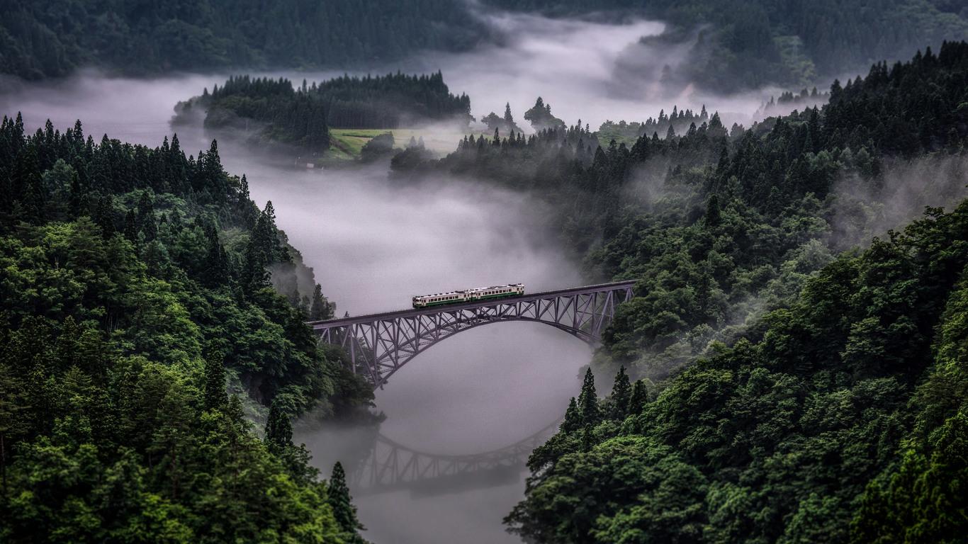 Train Going Over Bridge Surrounded By Trees And Train Going Over Bridge Surrounded By Trees And River