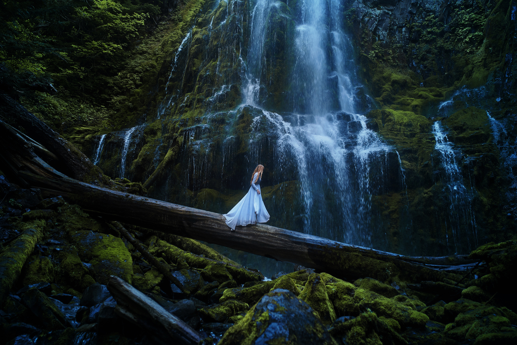 Girl at Cascading Waterfall Wallpaper
