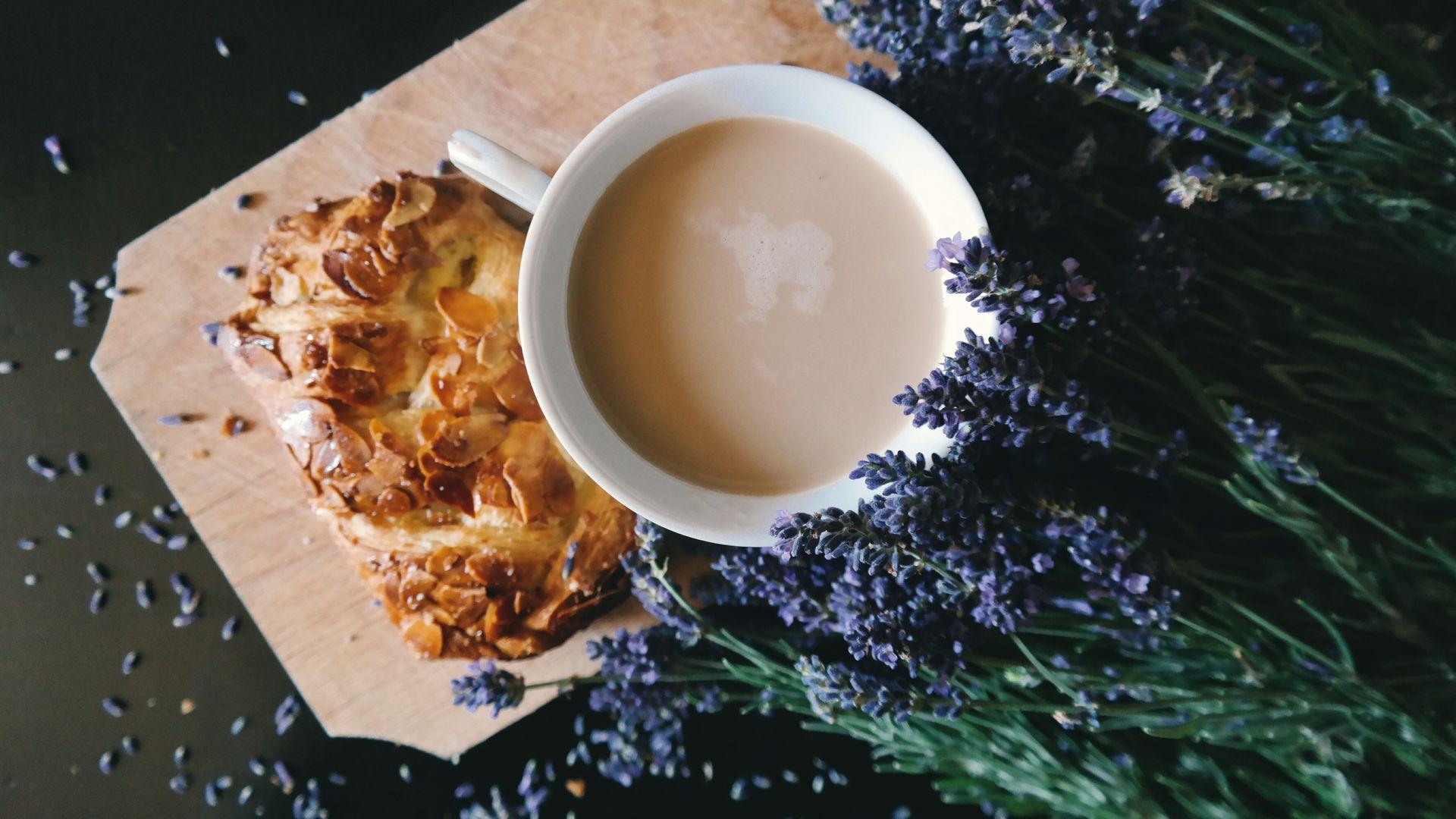 Coffee Mug Beside Purple Flowers and Pastry Wallpaper