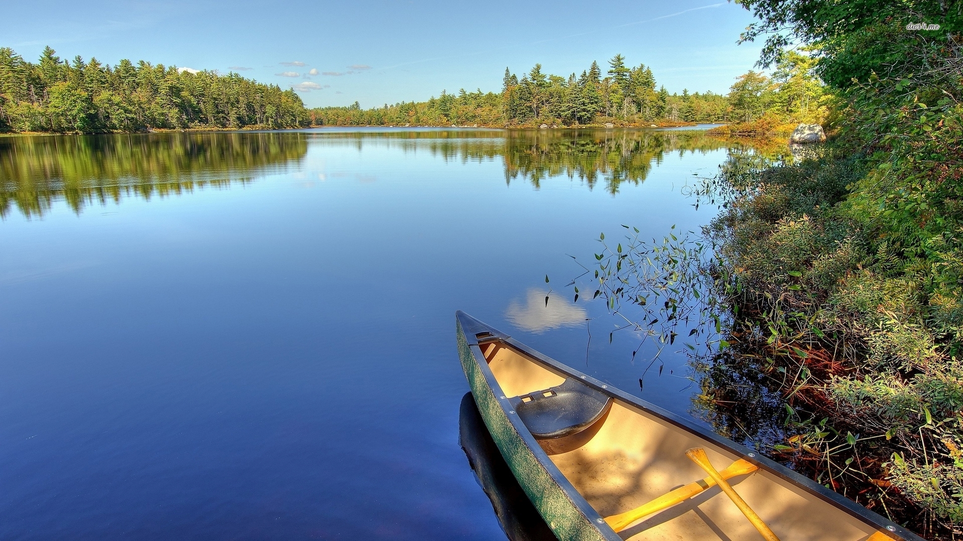 Canoe on a peaceful lake surrounded