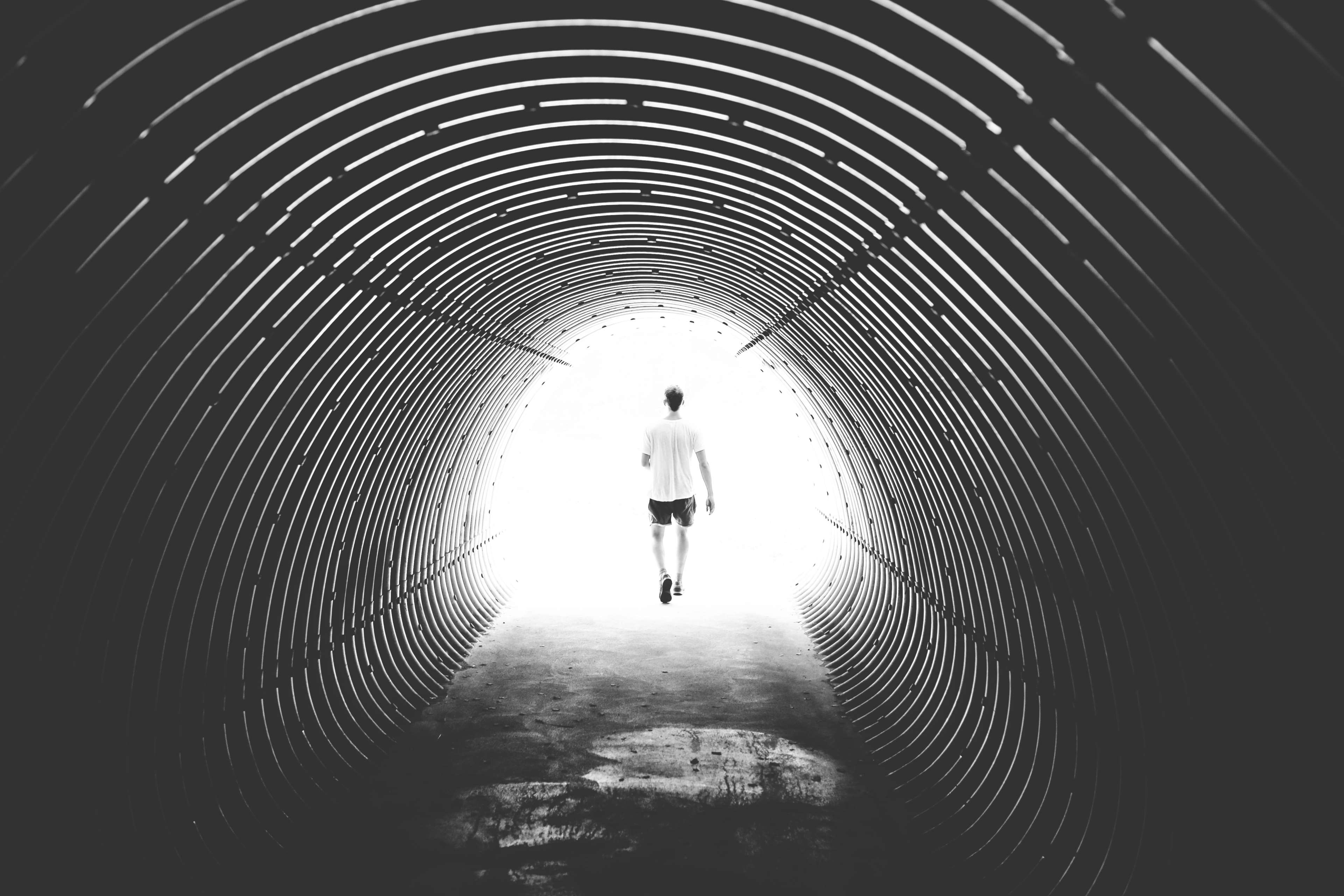 black and white, light, man, person, solo, tunnel, walking