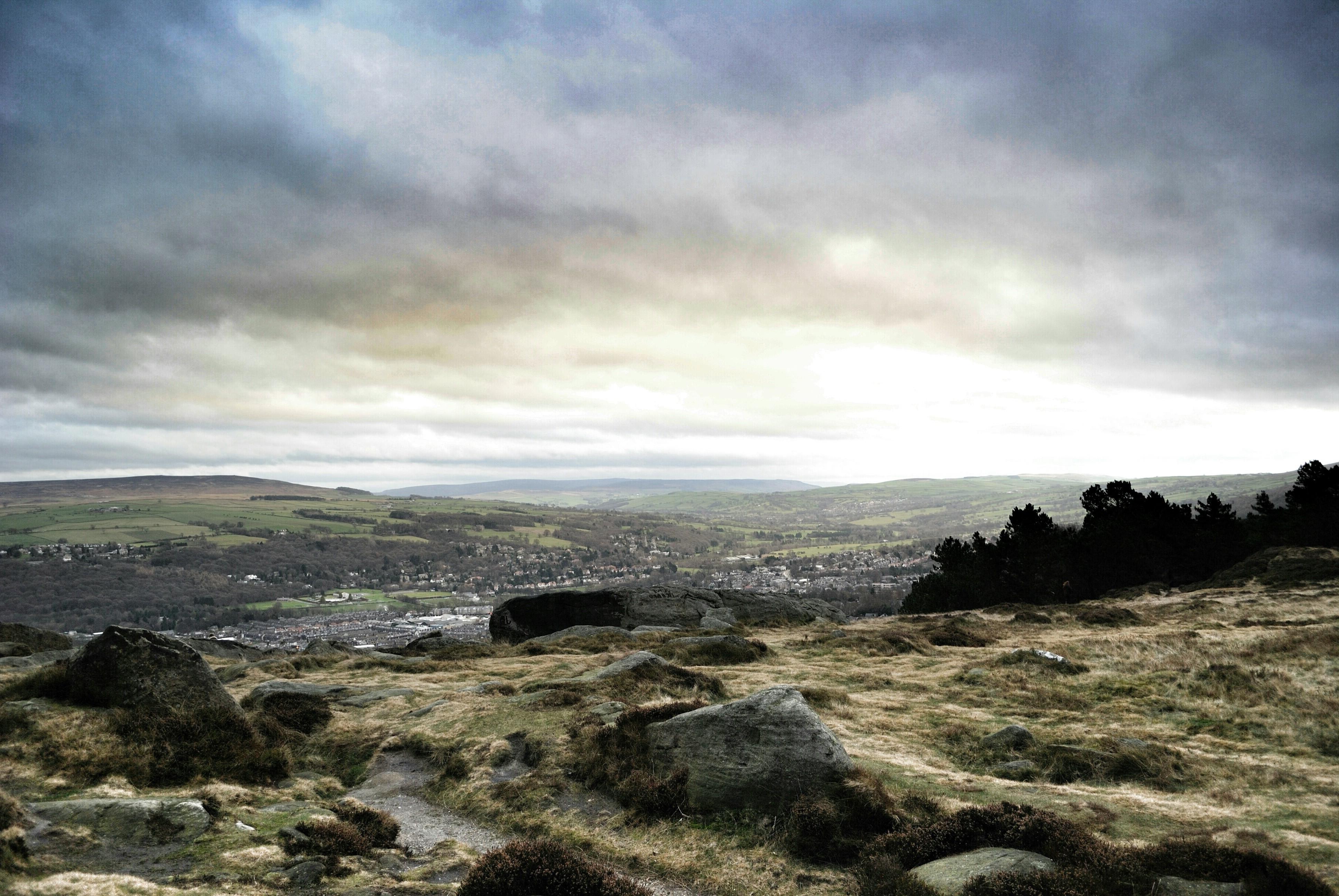 ilkley england hill landscape rock road clouds forest trees