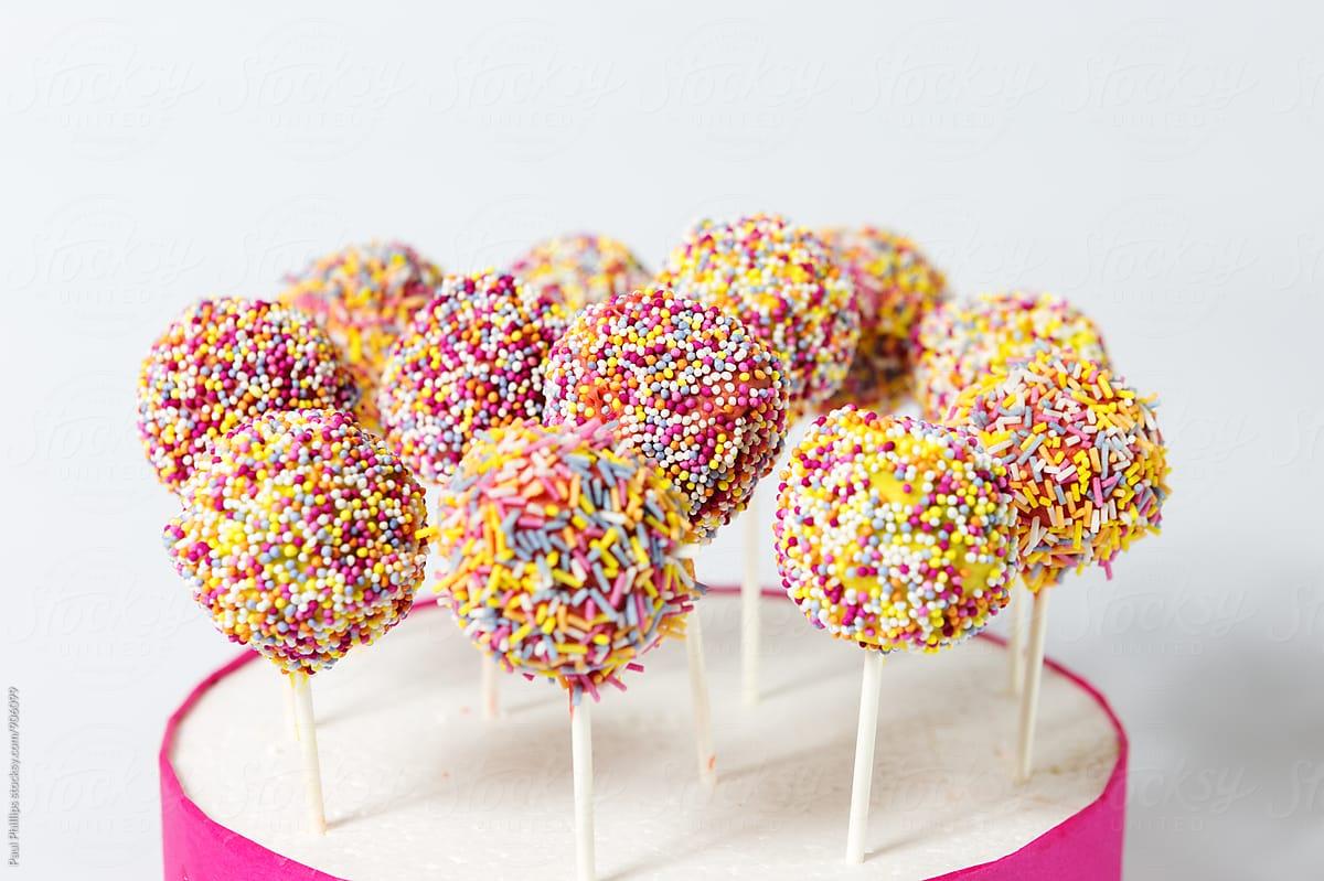 Party Cake Pops With Coloured Sprinkles. White Background. Stocksy