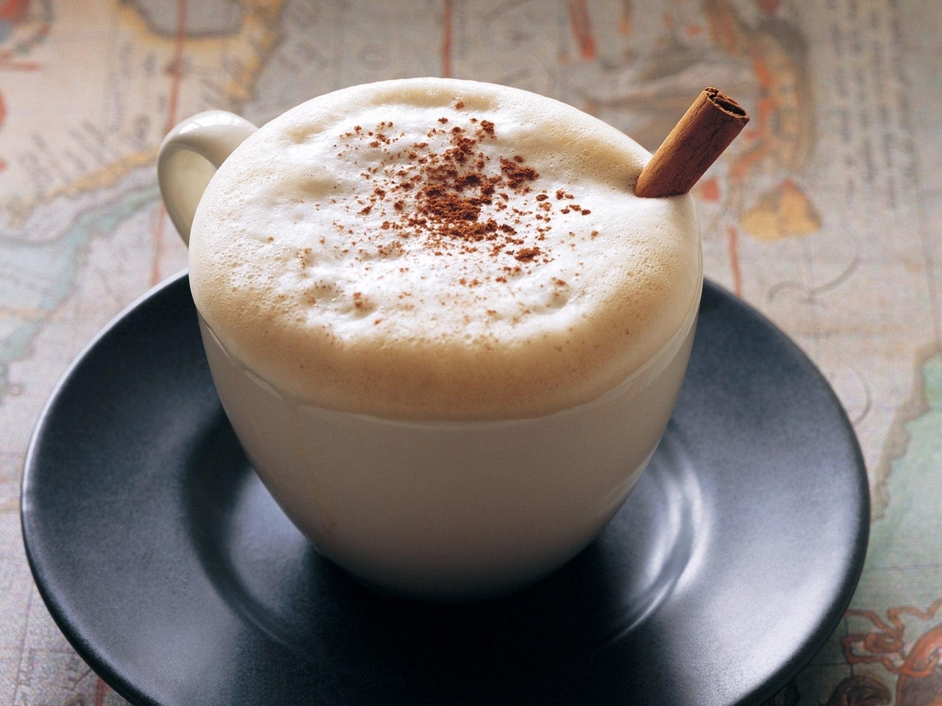 Cup of cappuccino on black saucer HD wallpaper
