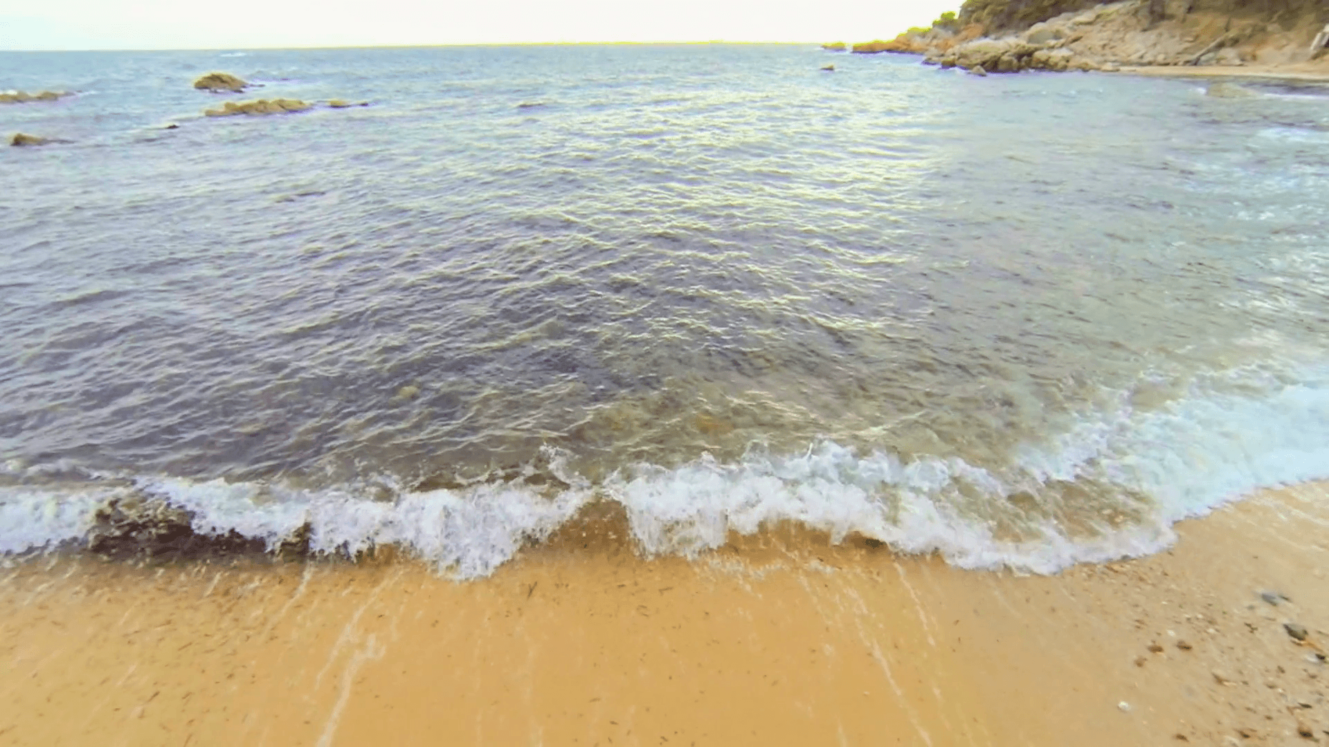 Aerial Drone View Mediterranean Unspoiled Virgin Beach. Aerial video shot in a typical Mediterranean beach. Moving along the seashore over Stones