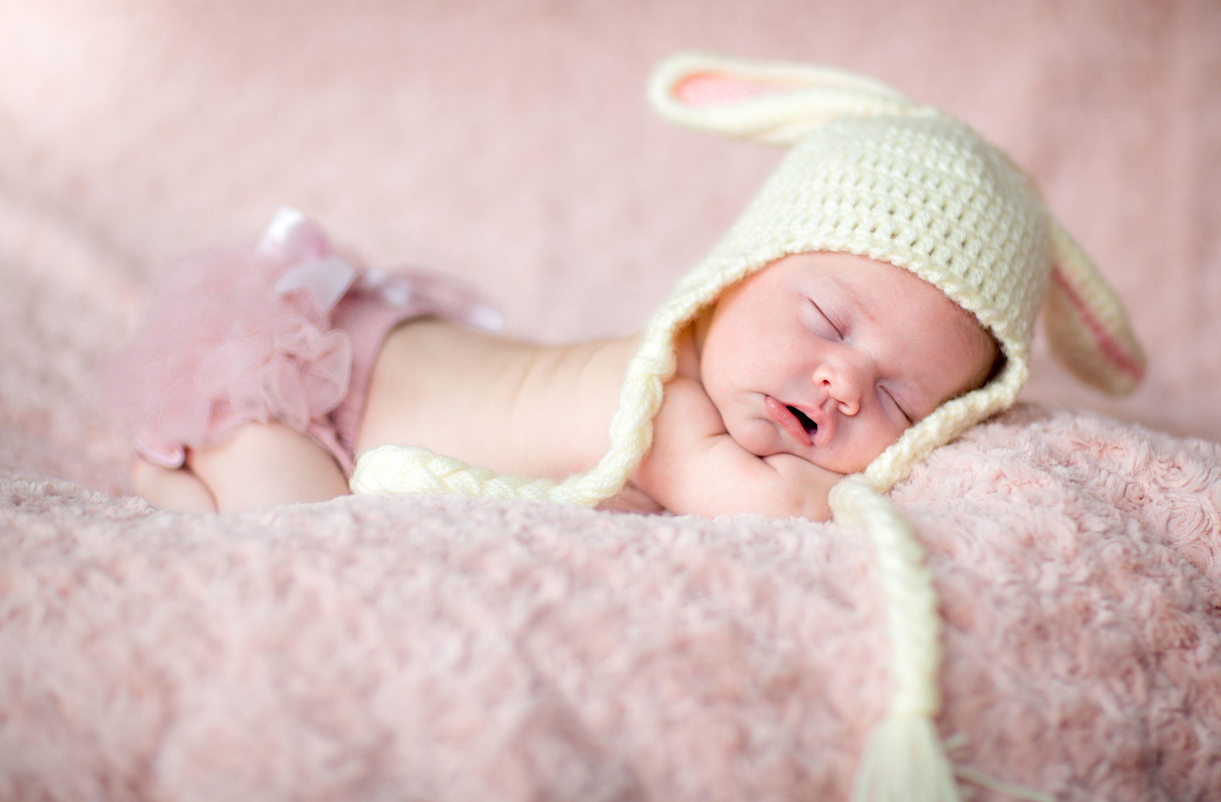 cute newborn baby girl sleeping picture on pink carpet Download