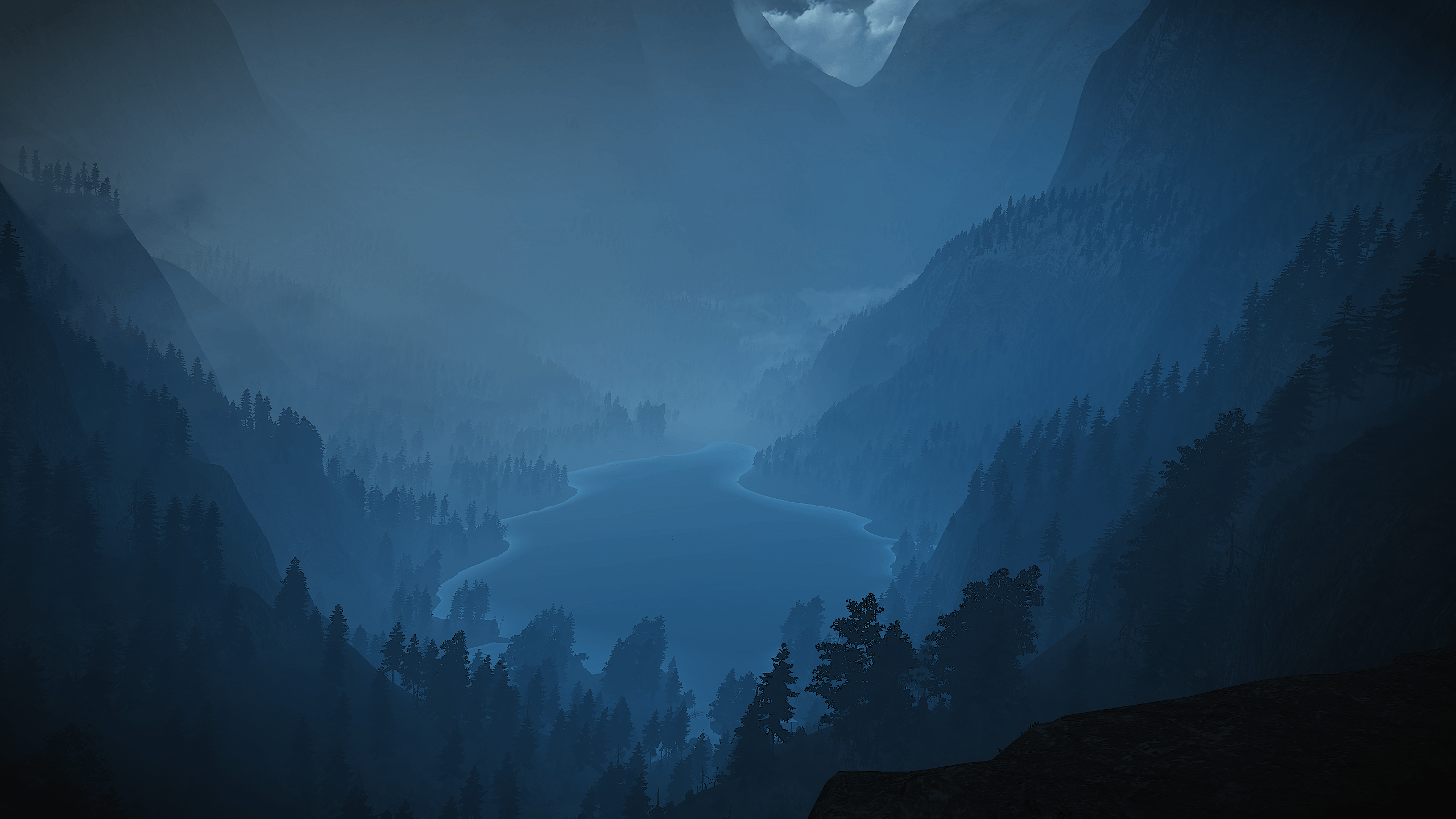 Foggy valley with a lake. 2560 × 1440