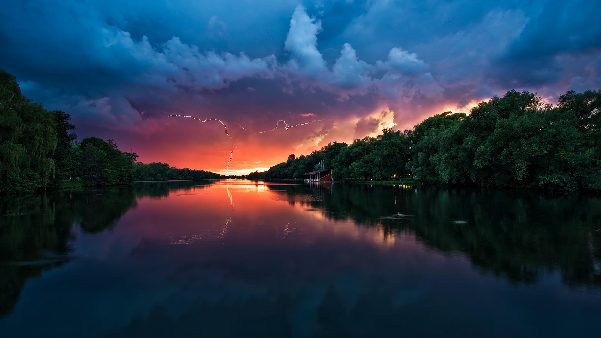 Sunset storm over the river 1920 × 1080