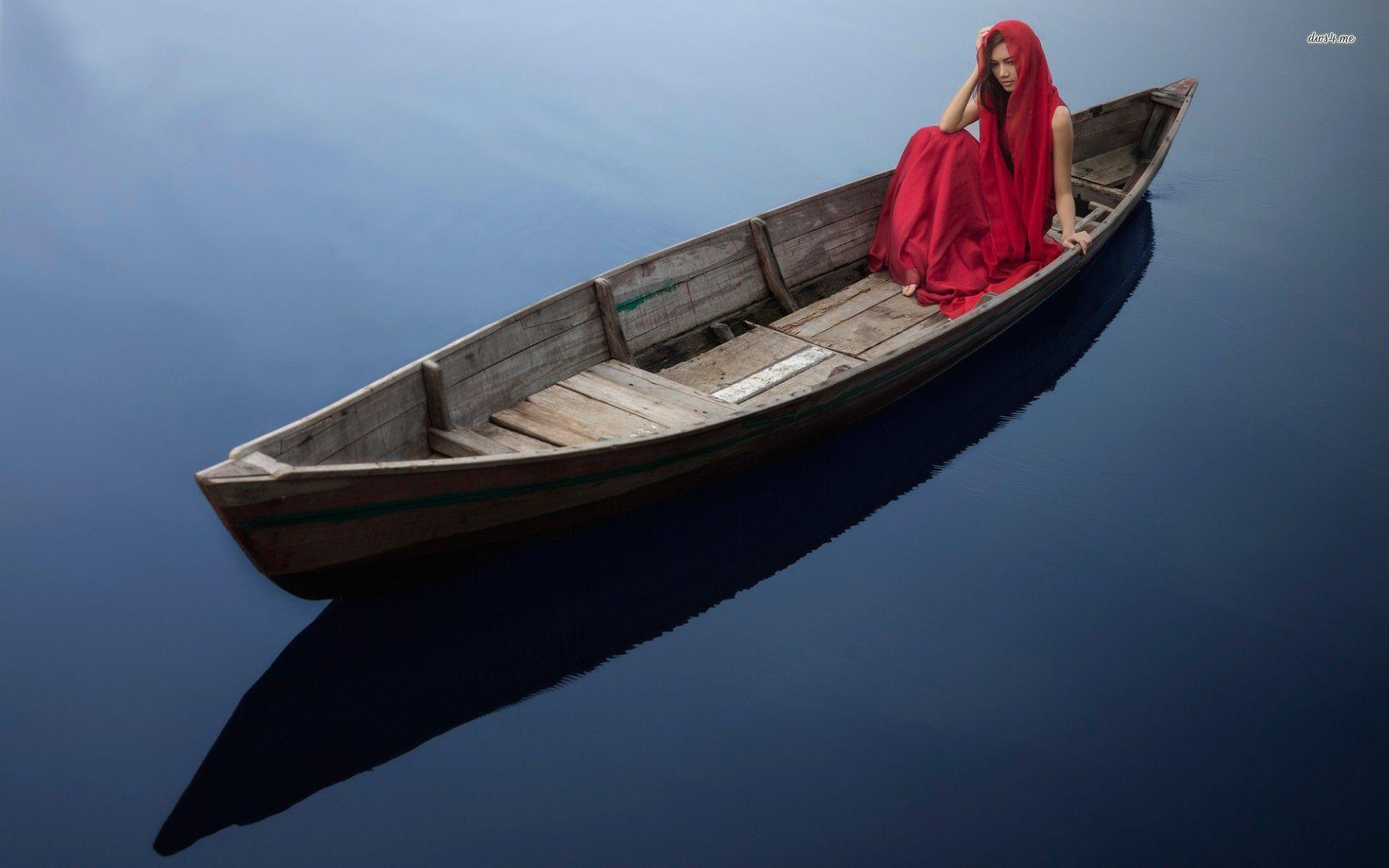 Woman in red dress in a boat wallpaper wallpaper