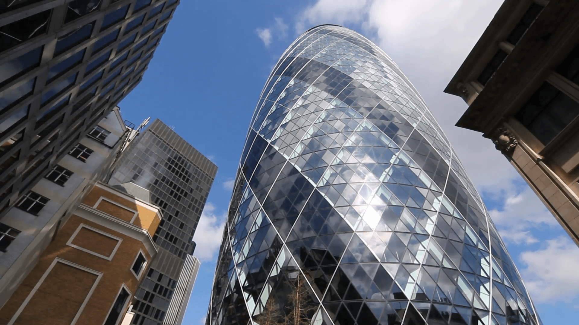 St Mary Axe, informally referred to as ‘The Gherkin’ and surrounding buildings. City of London, England. Stock Video Footage